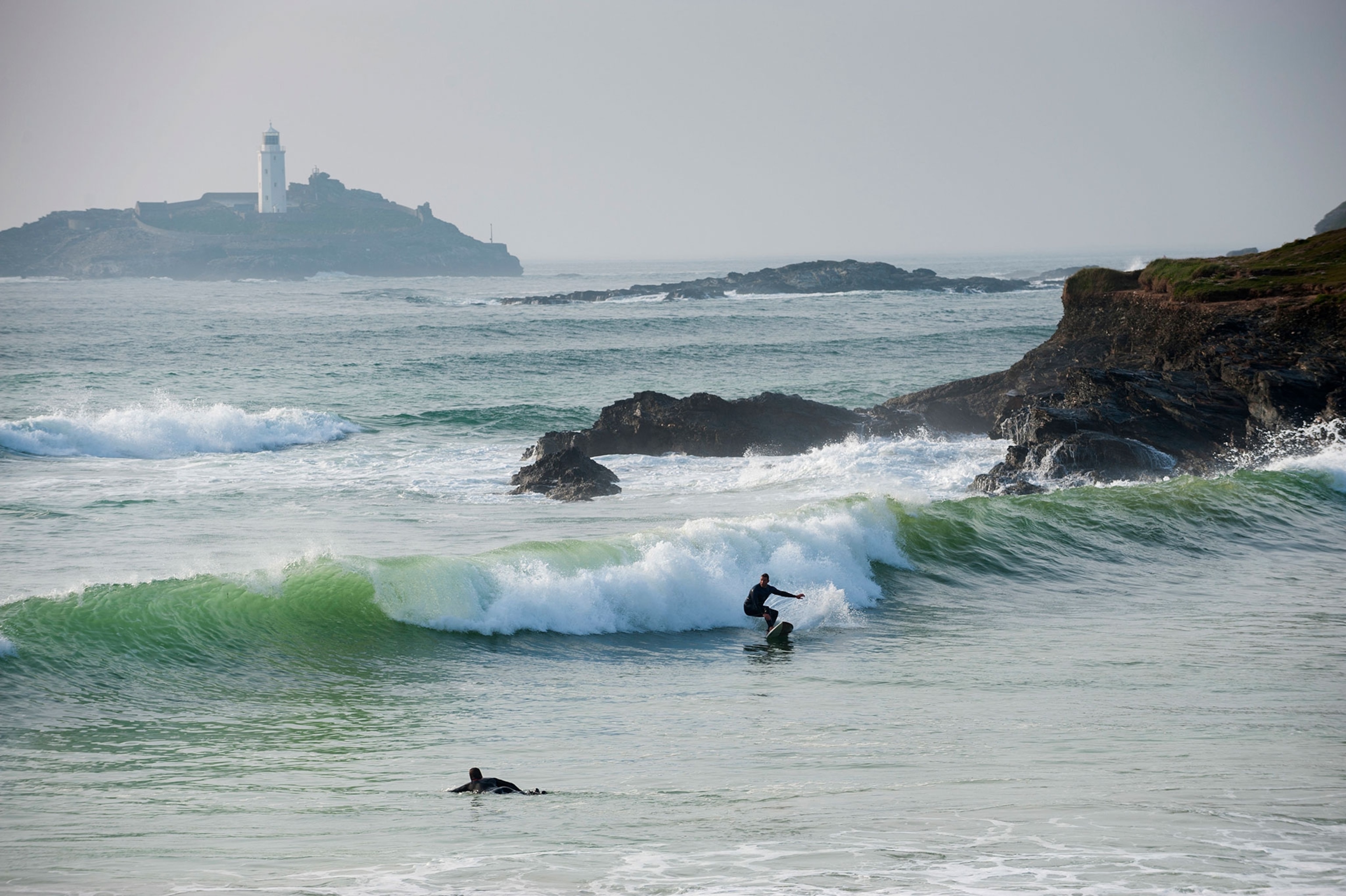 surfers in Cornwall, England