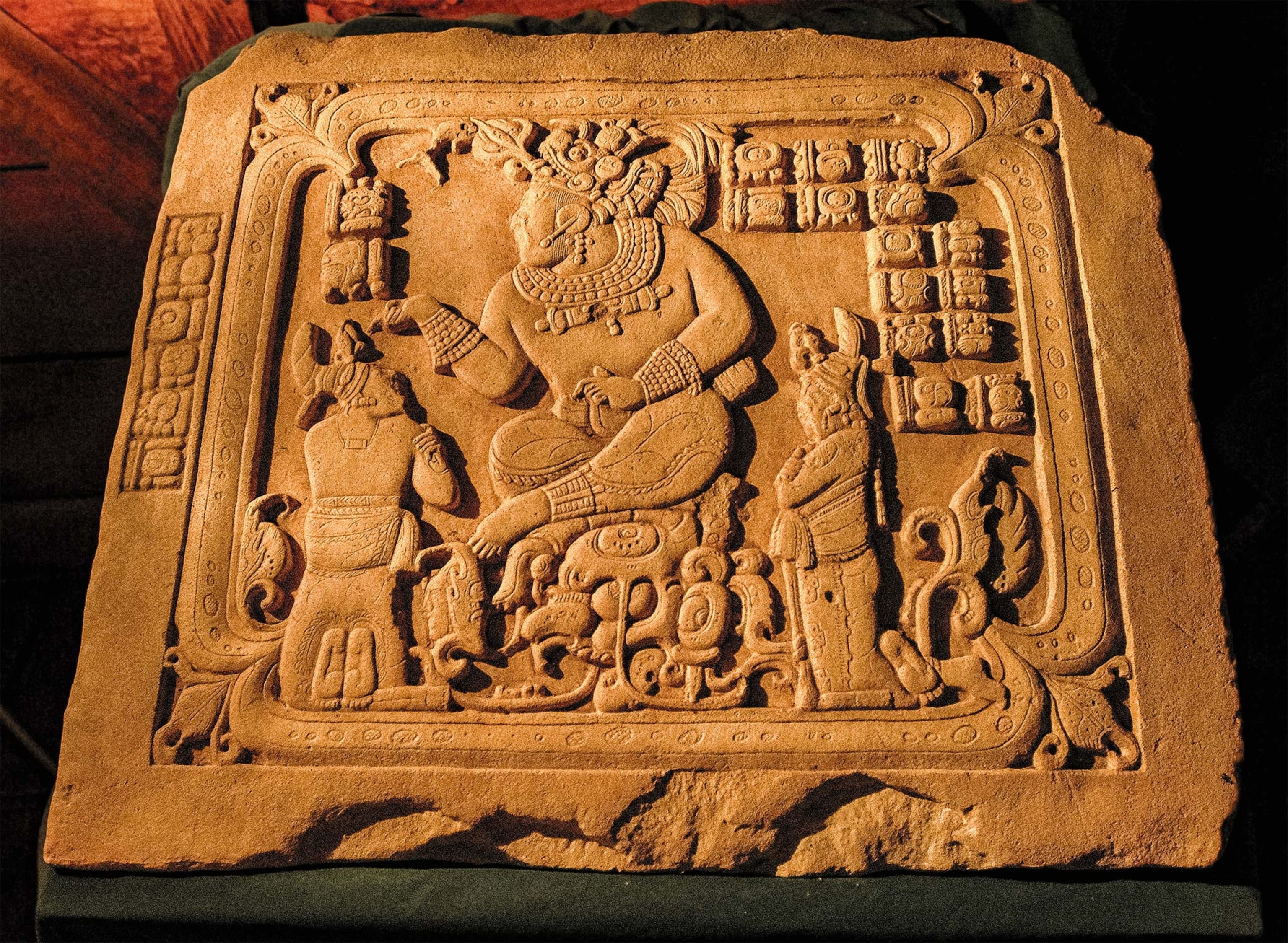 A panel carved in A.D. 795 shows the ajaw of Cancuén, Tajal Chan Ahk, together with a lower-ranking noble and a priest.