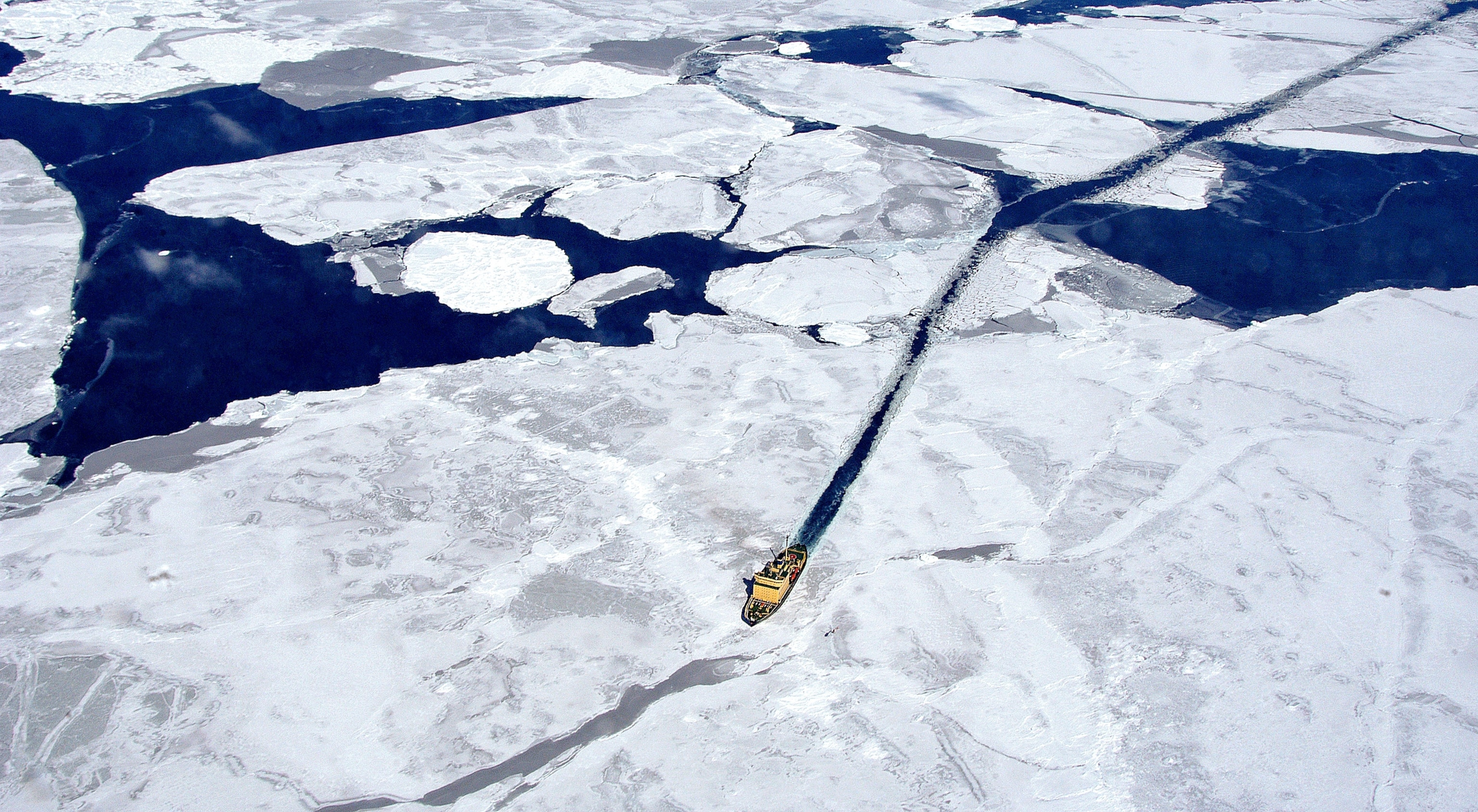 a ship breaking through ice on the way to Antarctica to see a solar eclipse