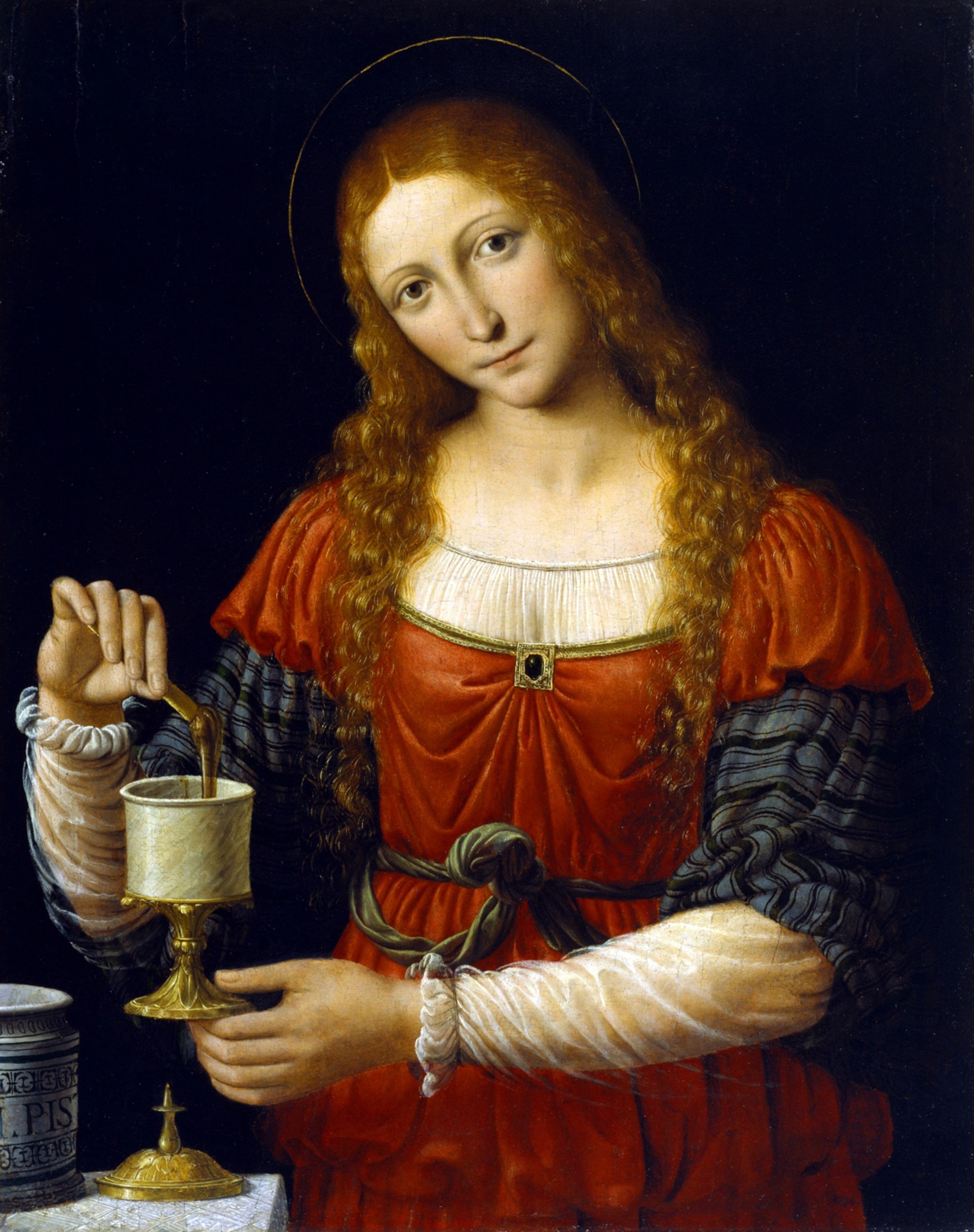 An oil painting of Mary Magdalene transferring ointment from a maiolica pharmacy jar to a smaller vessel.