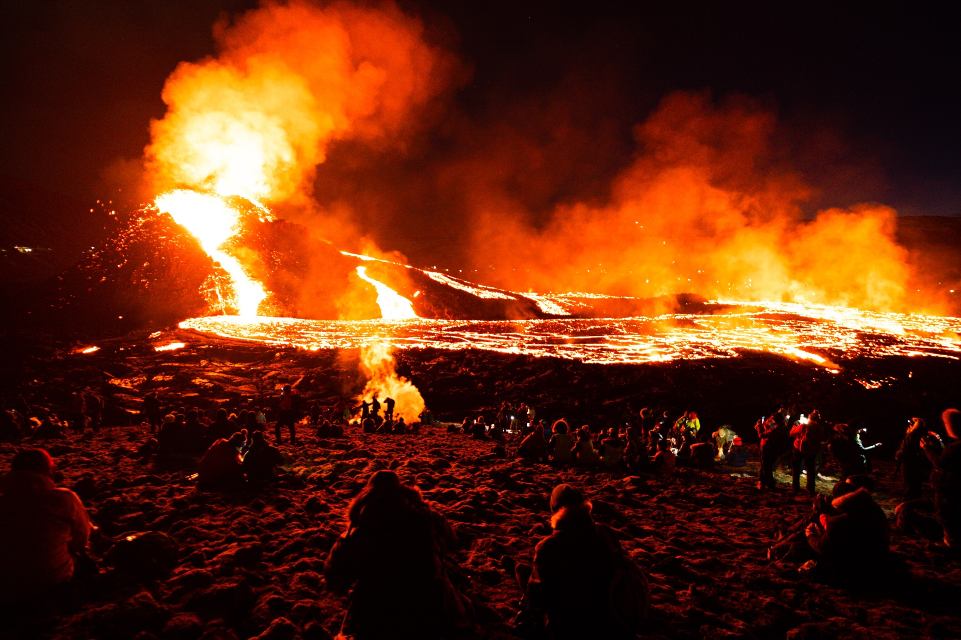 crowds of tourists walking around the flow of the erupted volcano