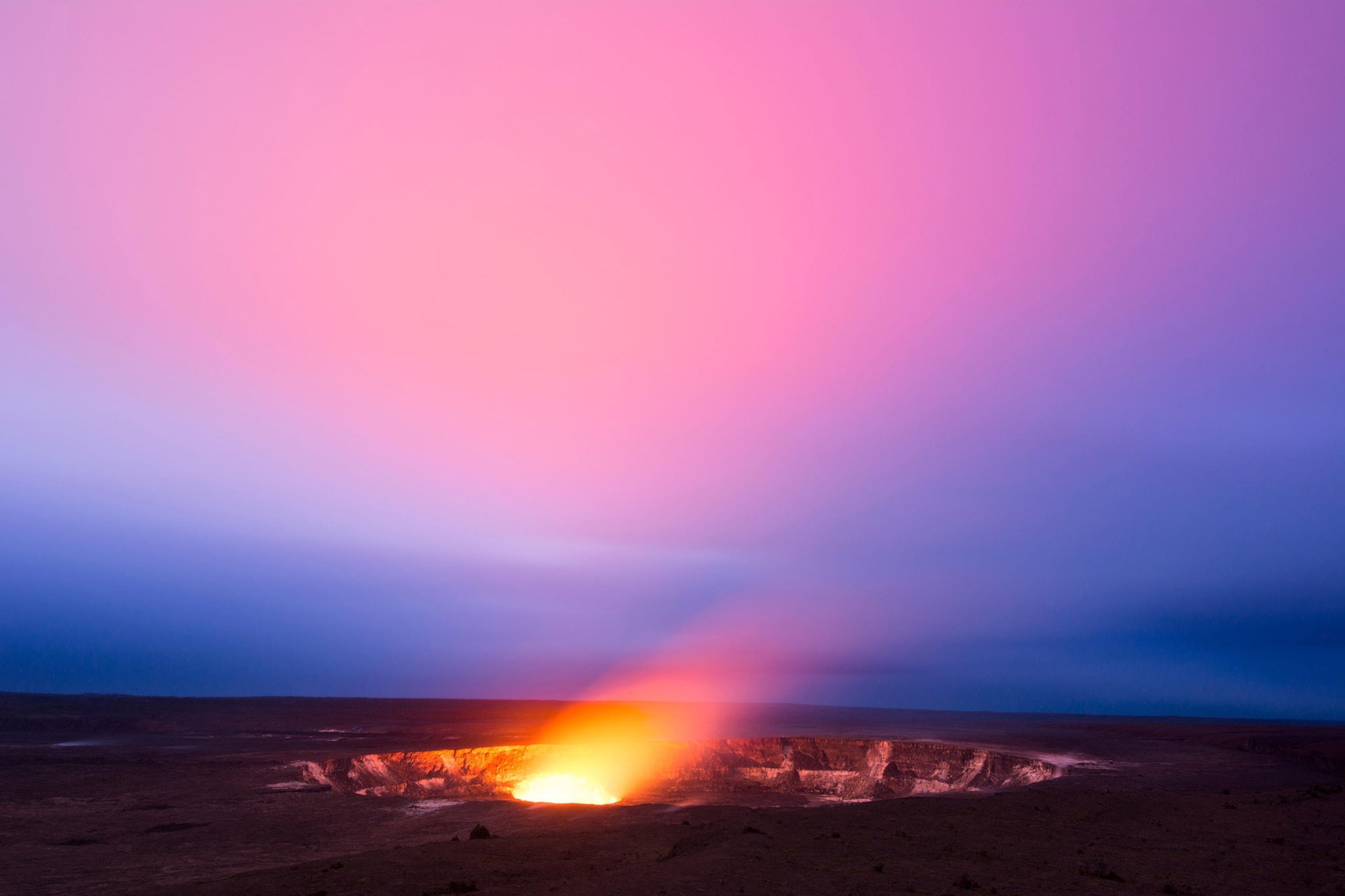 A pink sky above the glowing lava lake