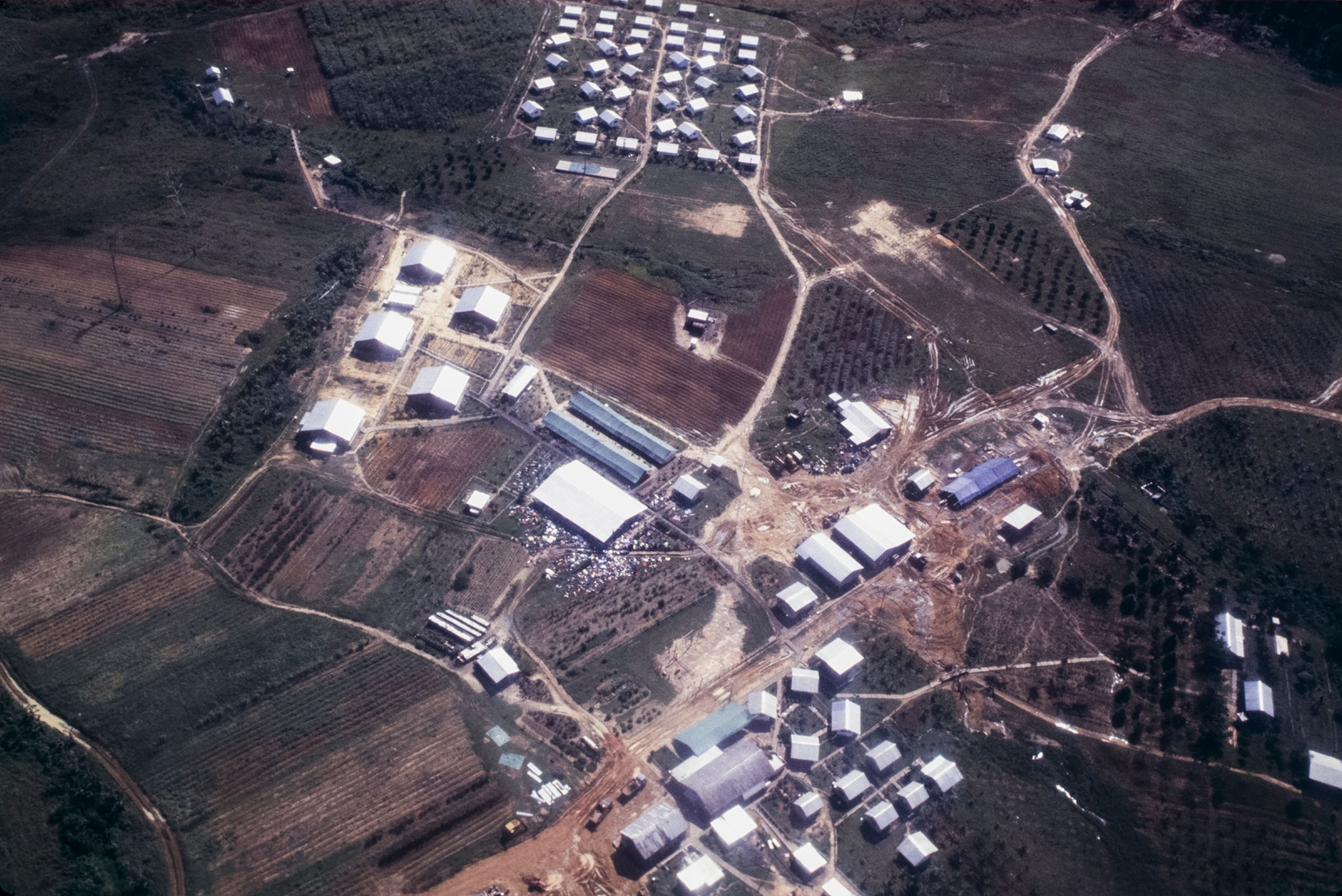 Aerial view of a large complex of buildings with Horrible discovery of the bodies of more than 900 followers of a cult