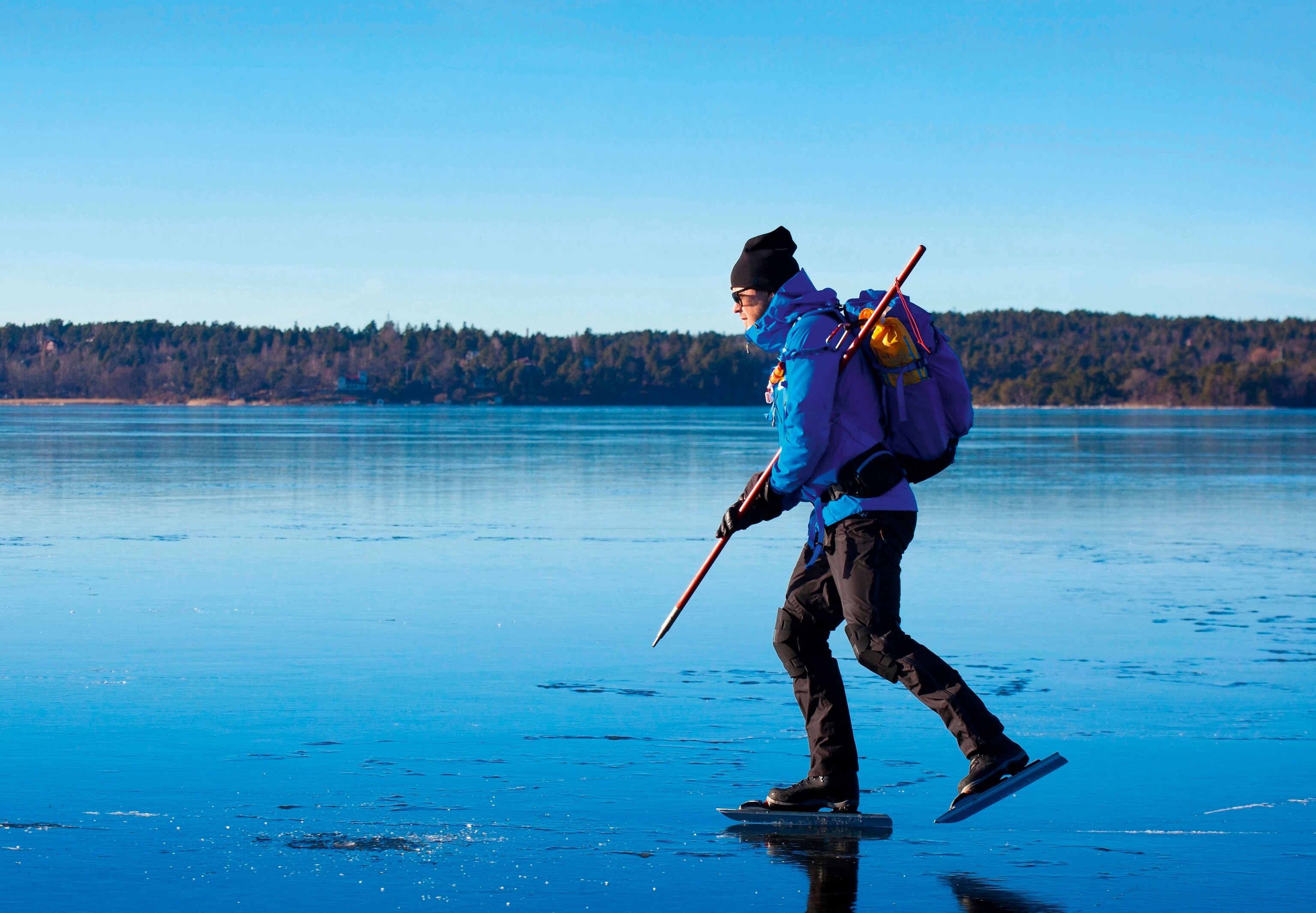 man ice-skating on real outdoor frozen lake