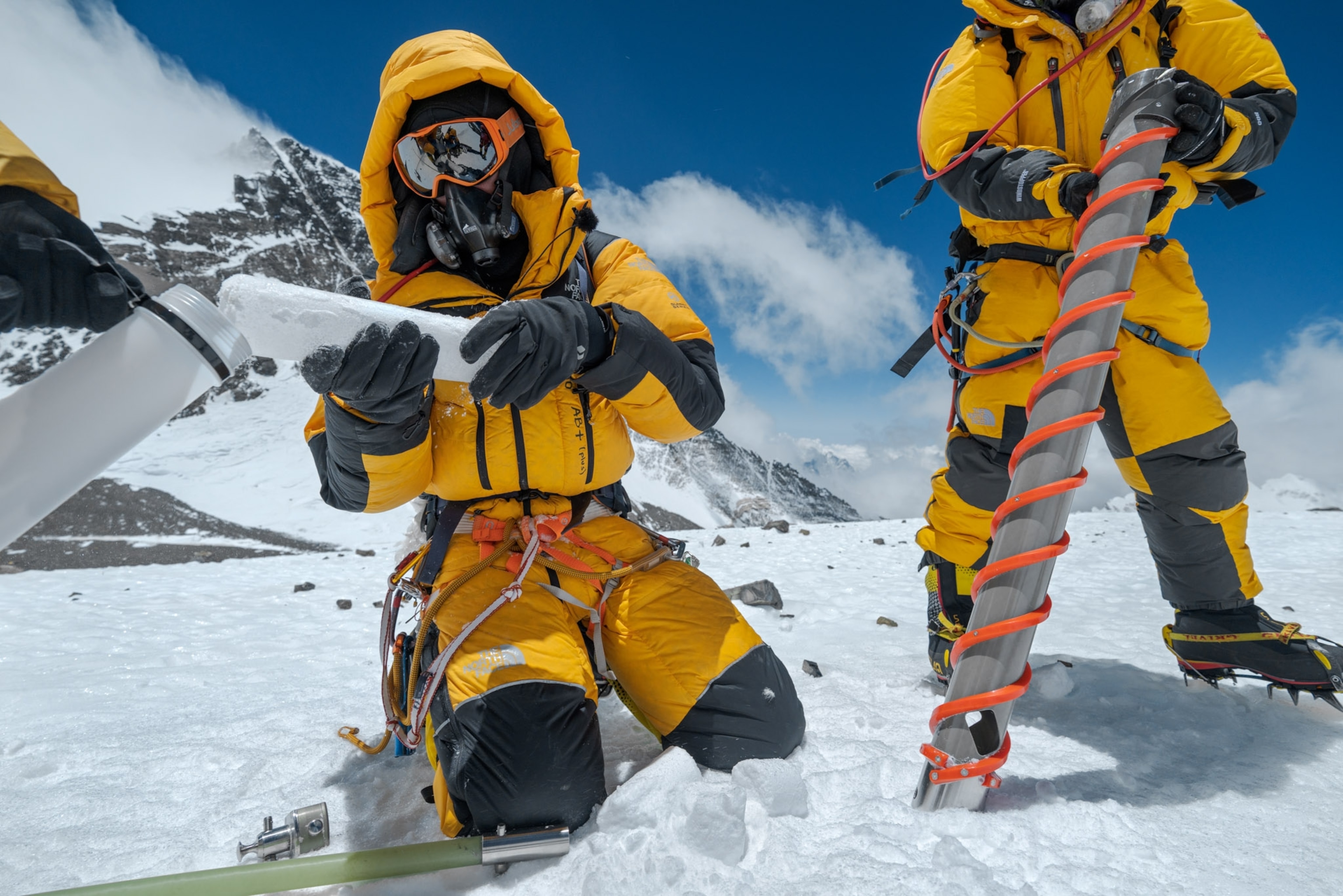 two men drilling and storing ice