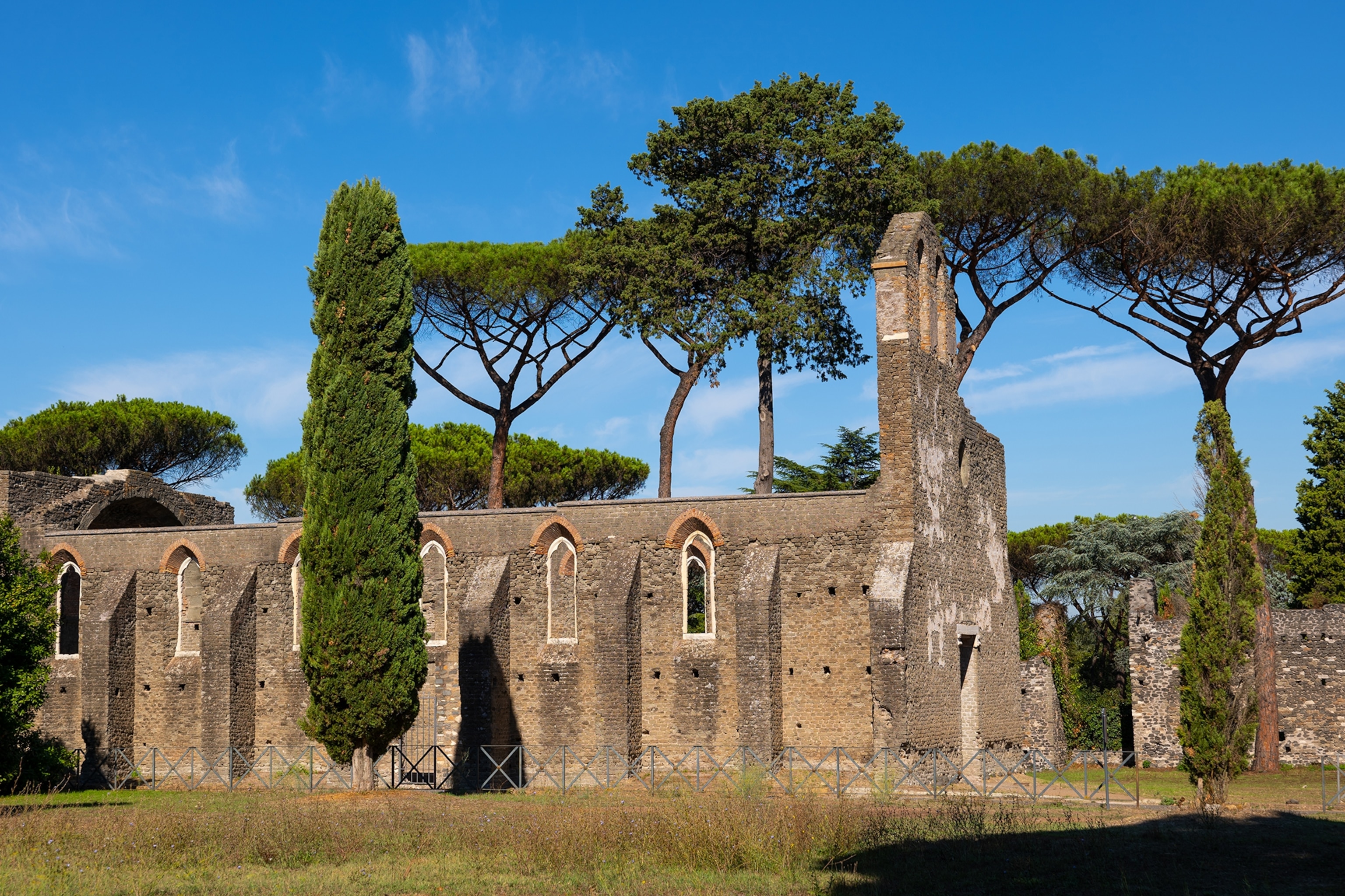 Ruins of a stone church surrounded by trees