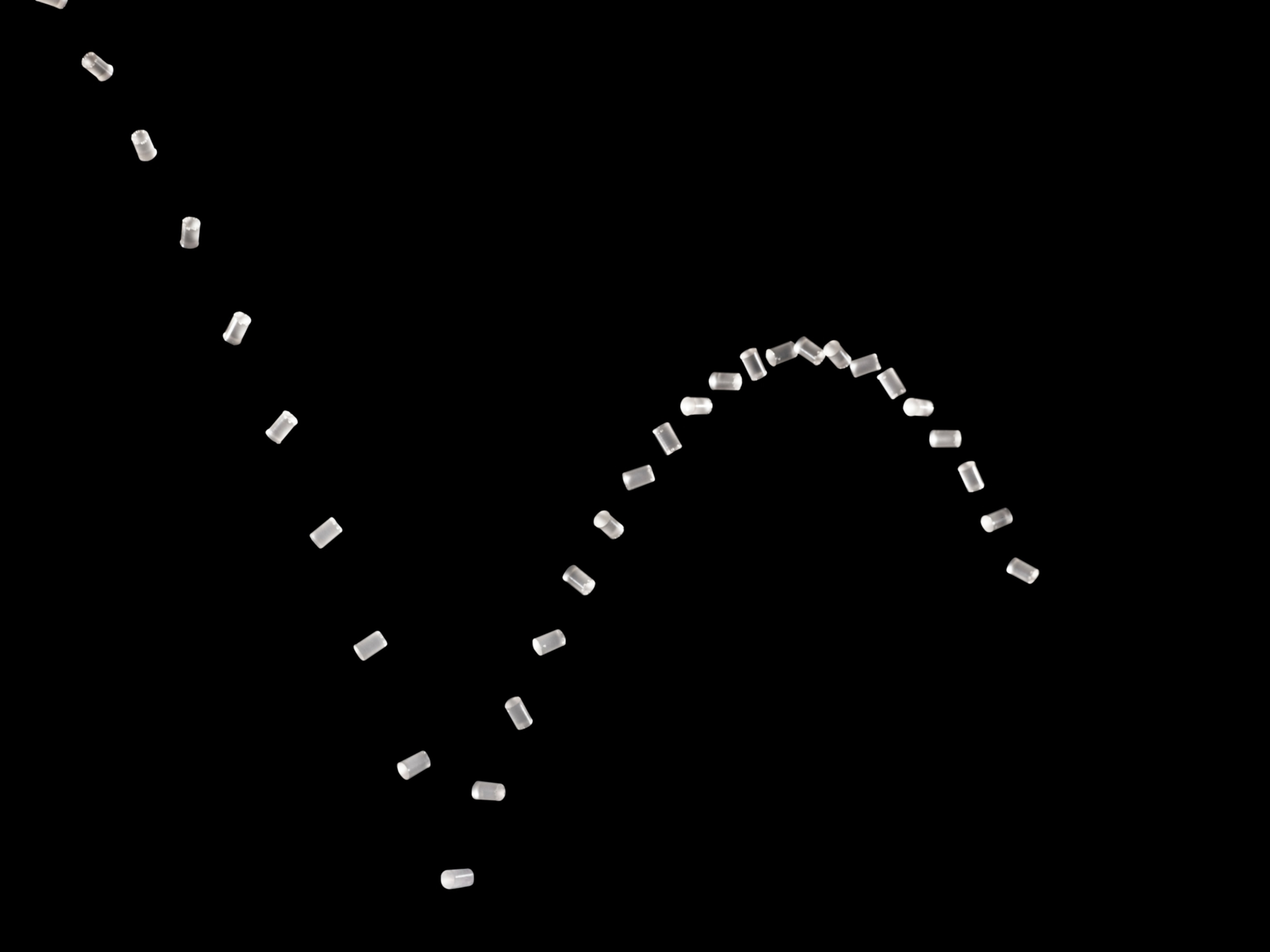 multiple apearances of the same piece of glass bouncing in an arc across a black background.