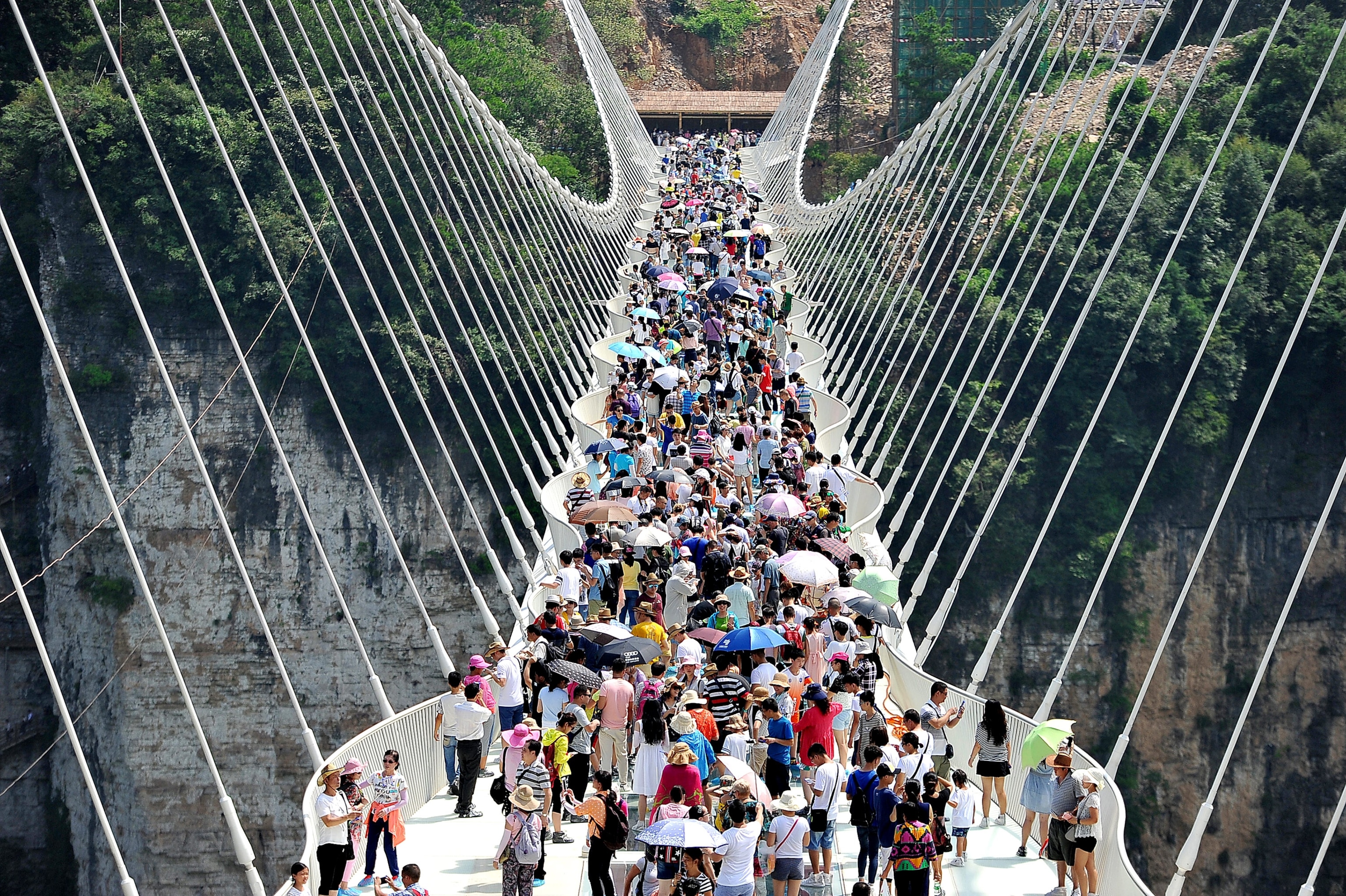 tourists visiting on the glass-bottom bridge at Zhangjiajie Grand Canyon, China