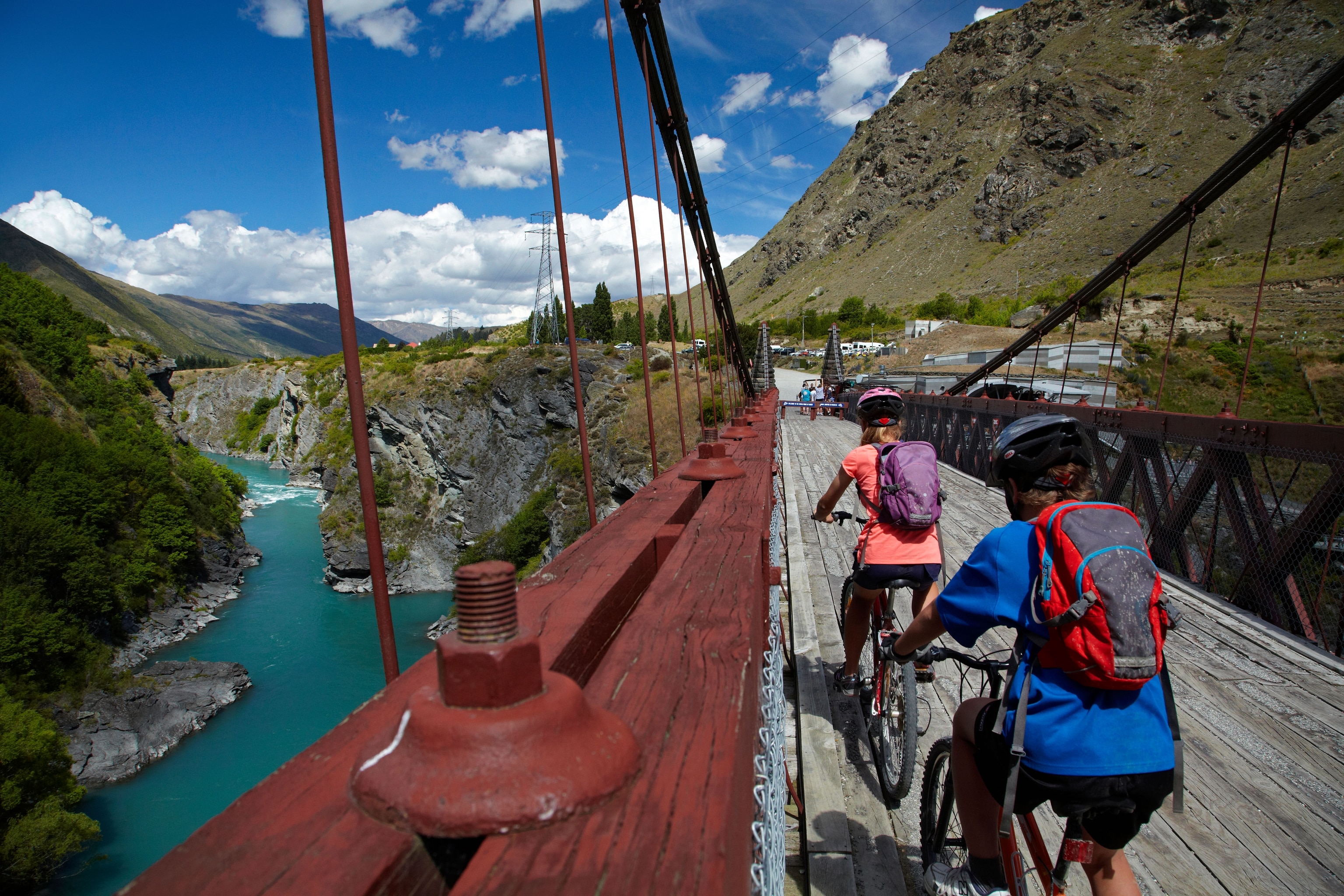 Mountain bikers crossing Historic Kawarau Bridge (Bungy Bridge) on Arrow River Bridges Ride, Otago, South Island, New Zealand.