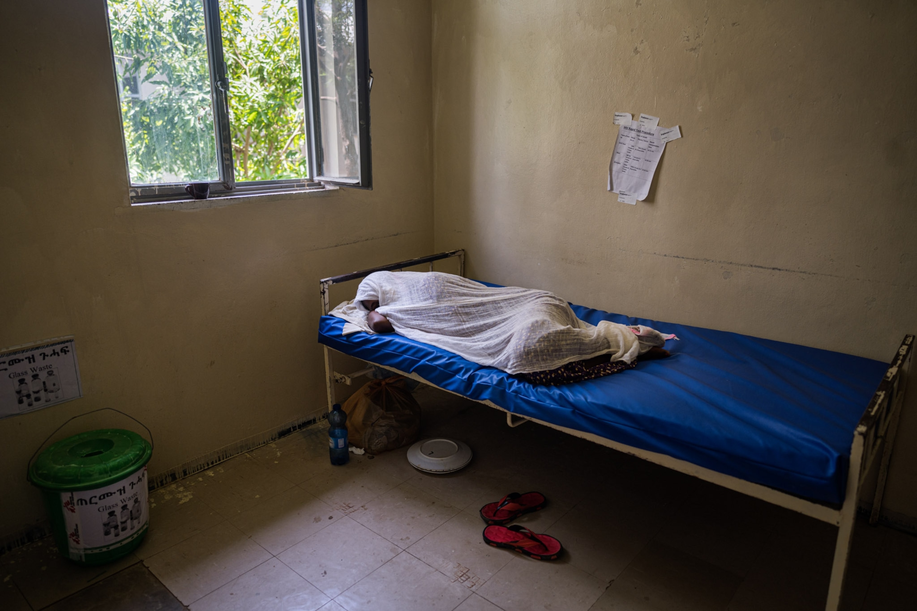young woman laying in hospital bed