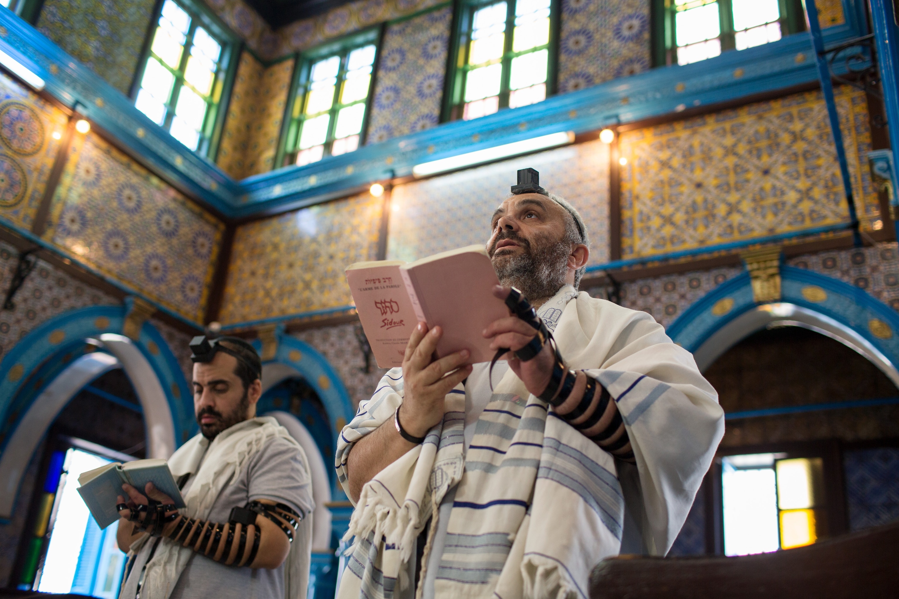 men praying inside the Ghriba synagogue in Djerba, Tunisia