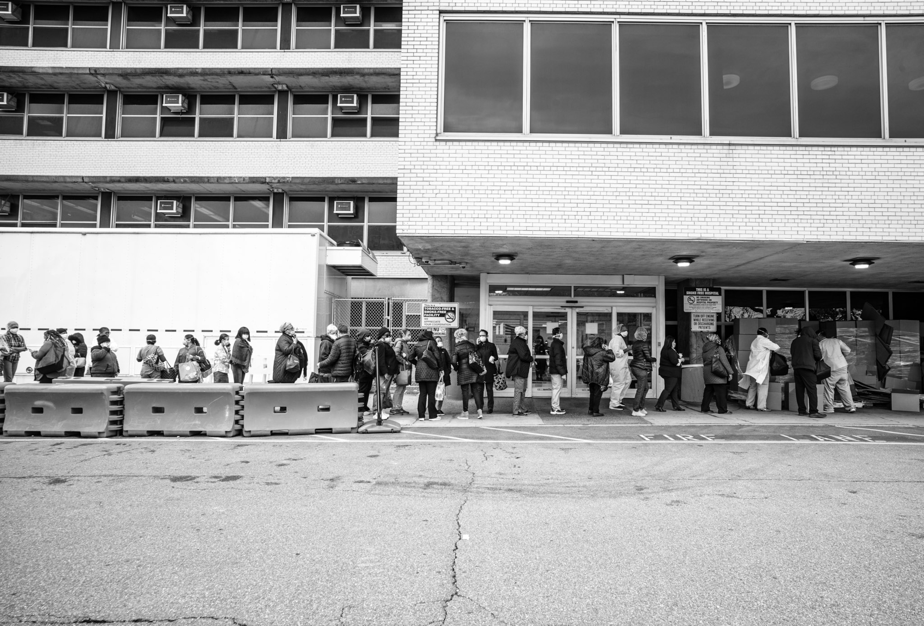 a row of people standing outside of a set of double doors