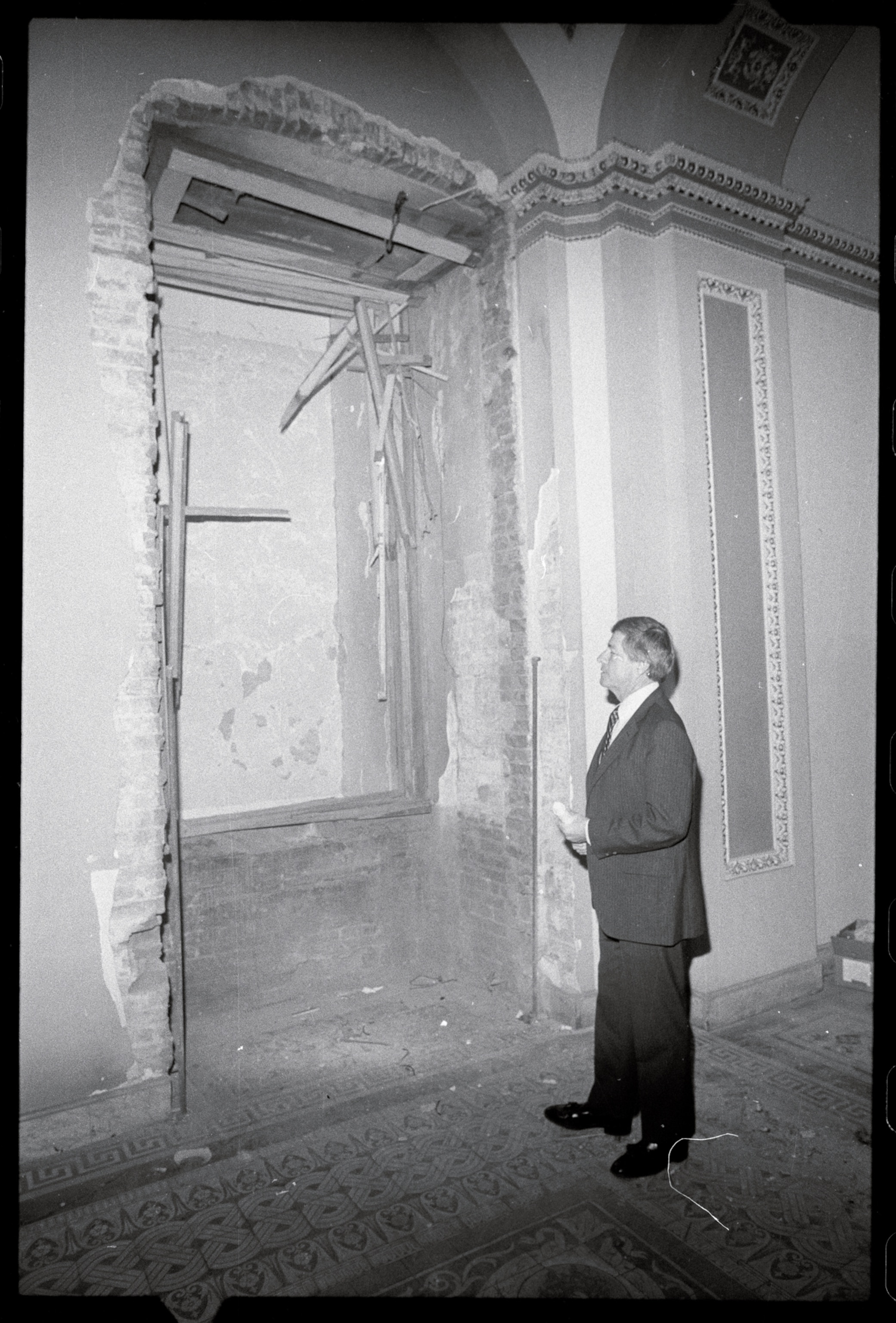 a person staring at a large whole in a wall