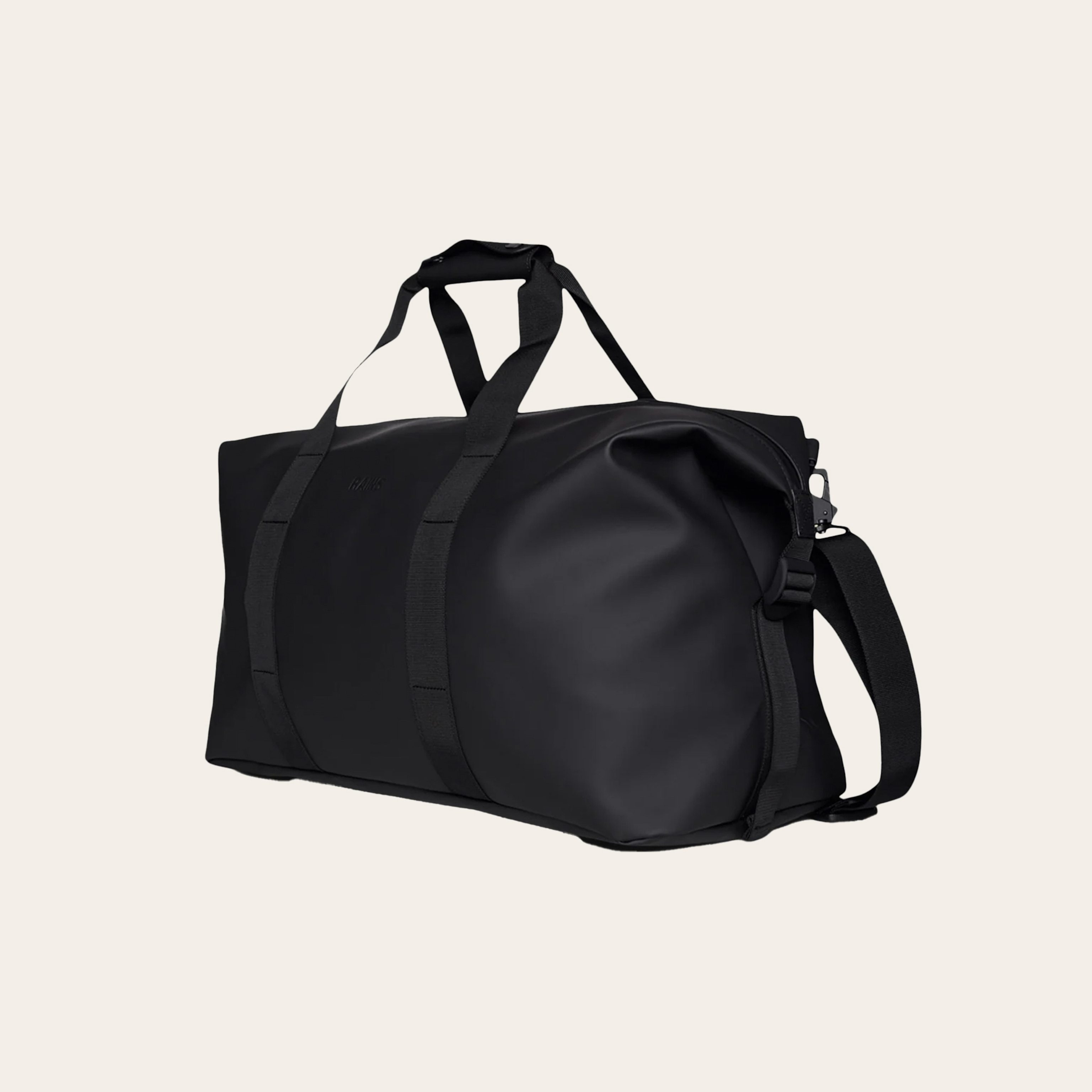 A black duffel bag against a tan background.