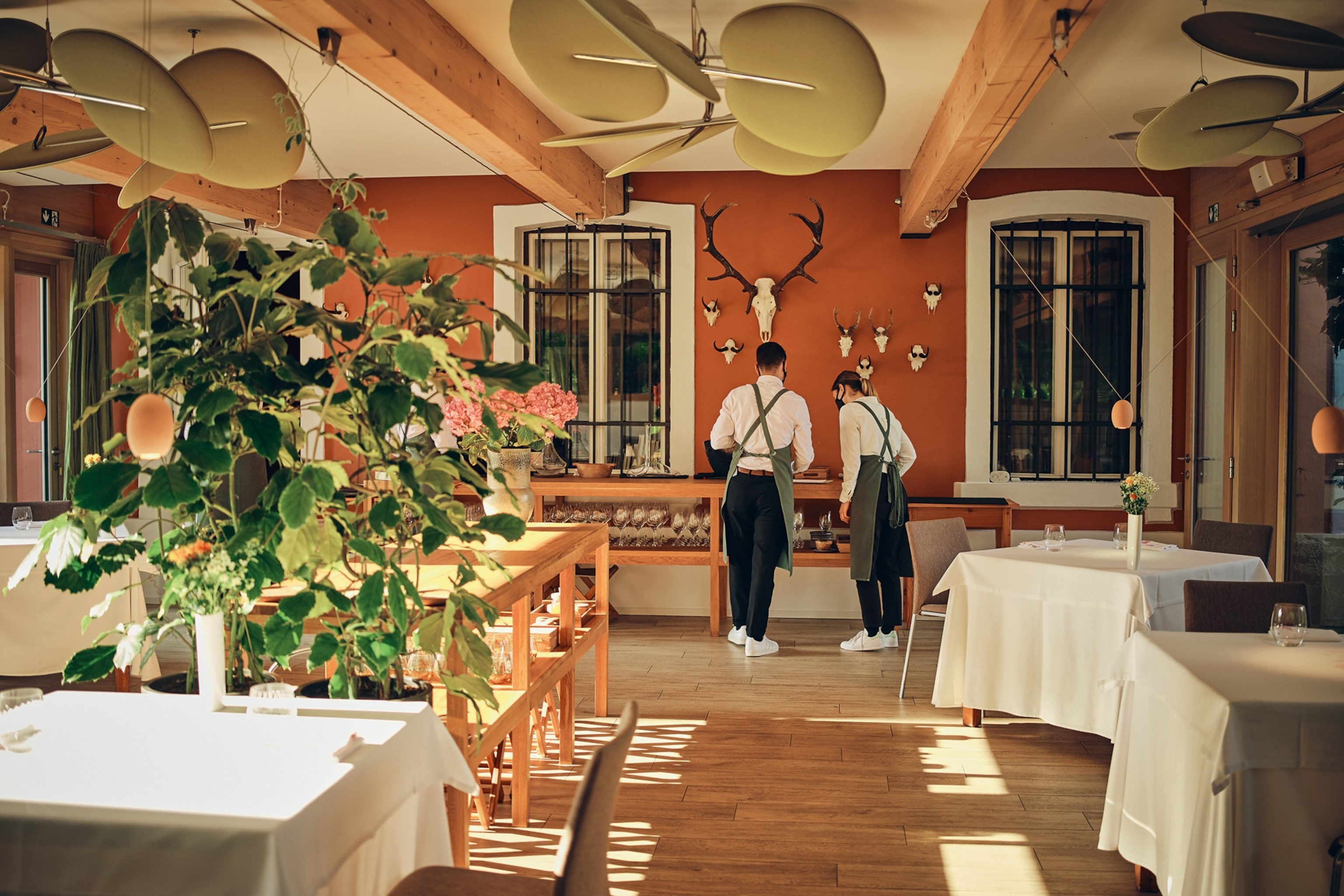 A restaurant dining room with wooden floors and beams.
