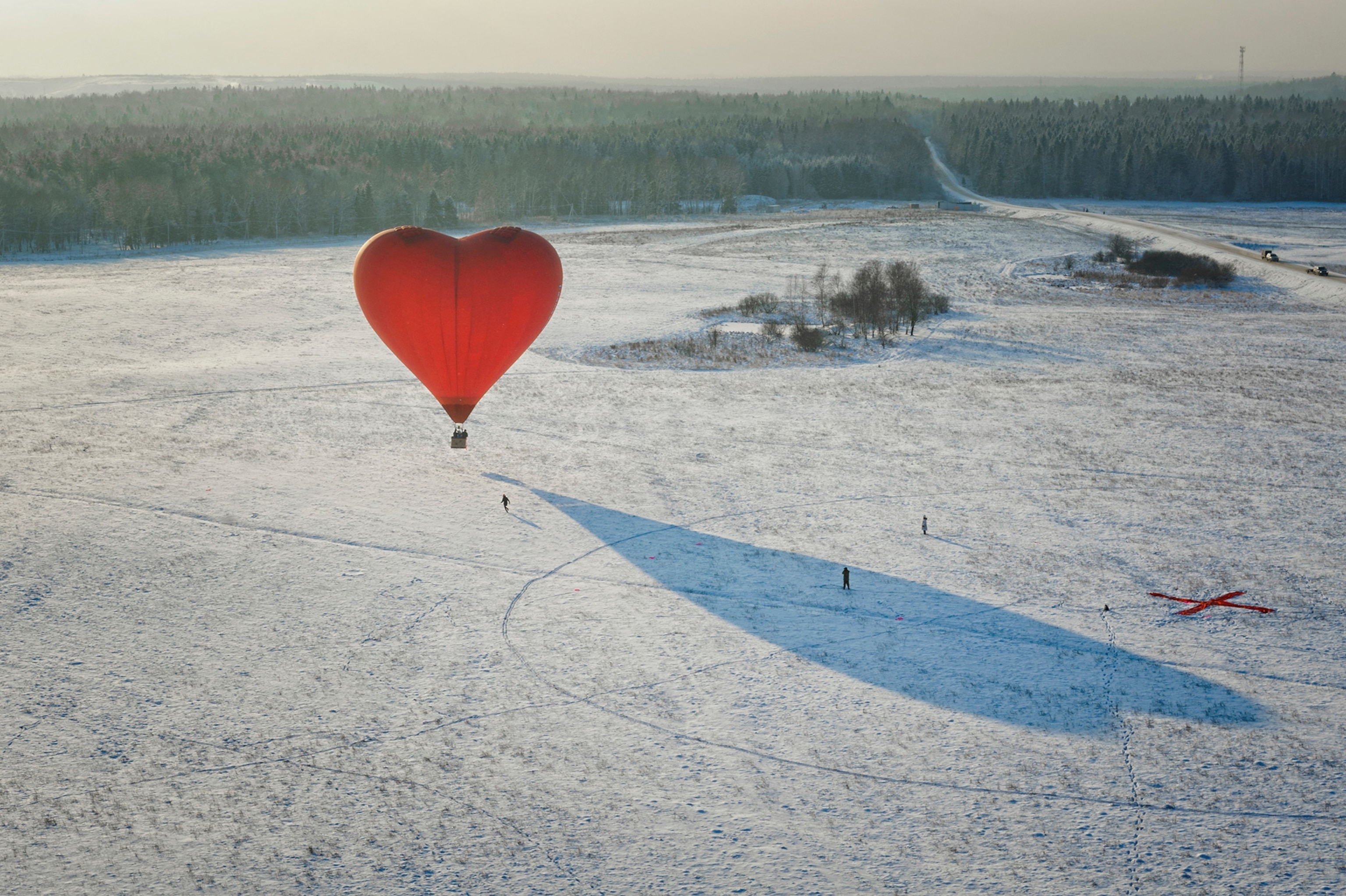High Angle View Of Heart Shape Hot Air Balloon On Snow Covered Land.