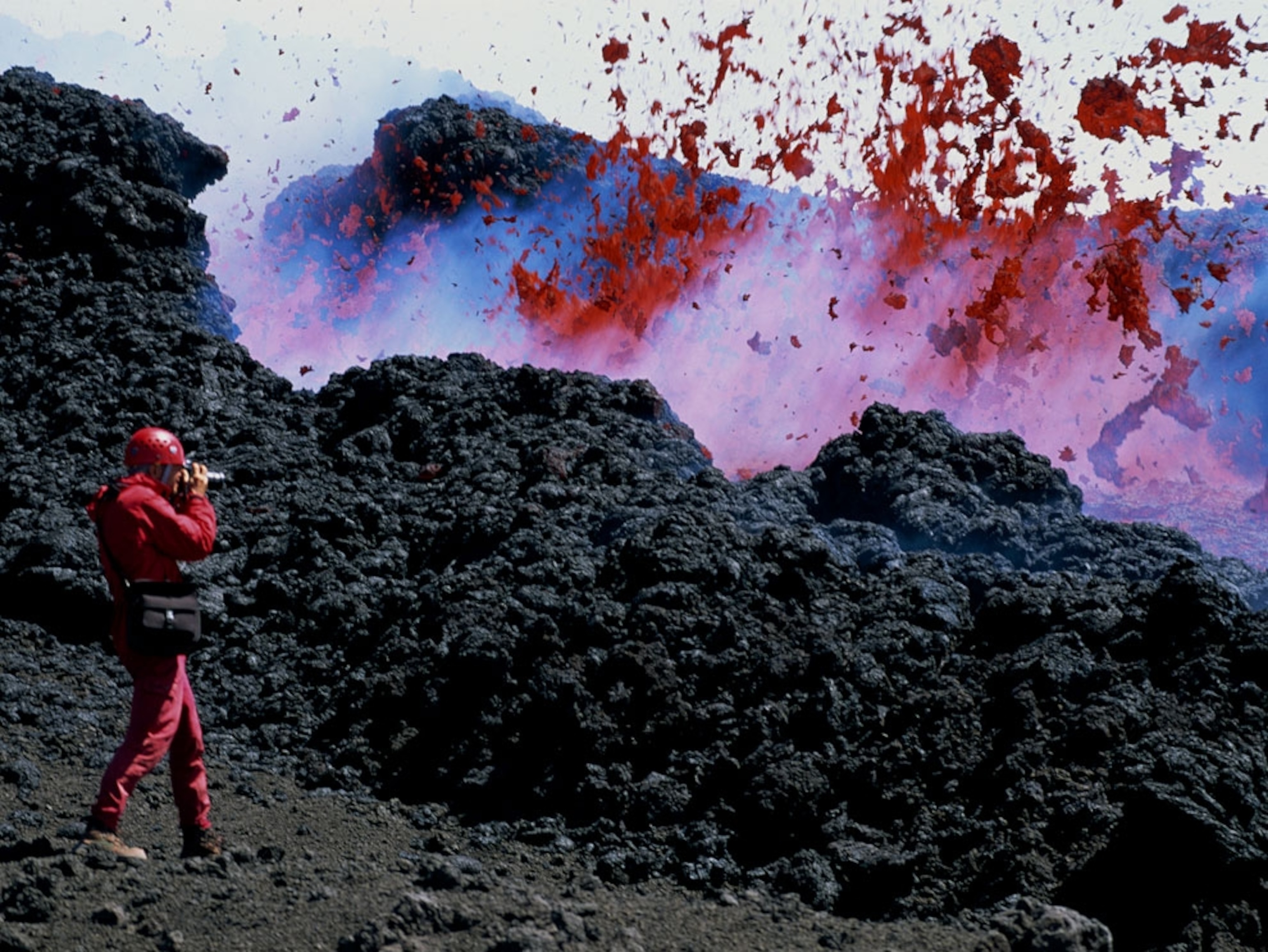 Photographer shooting lava explosion on Mount Etna