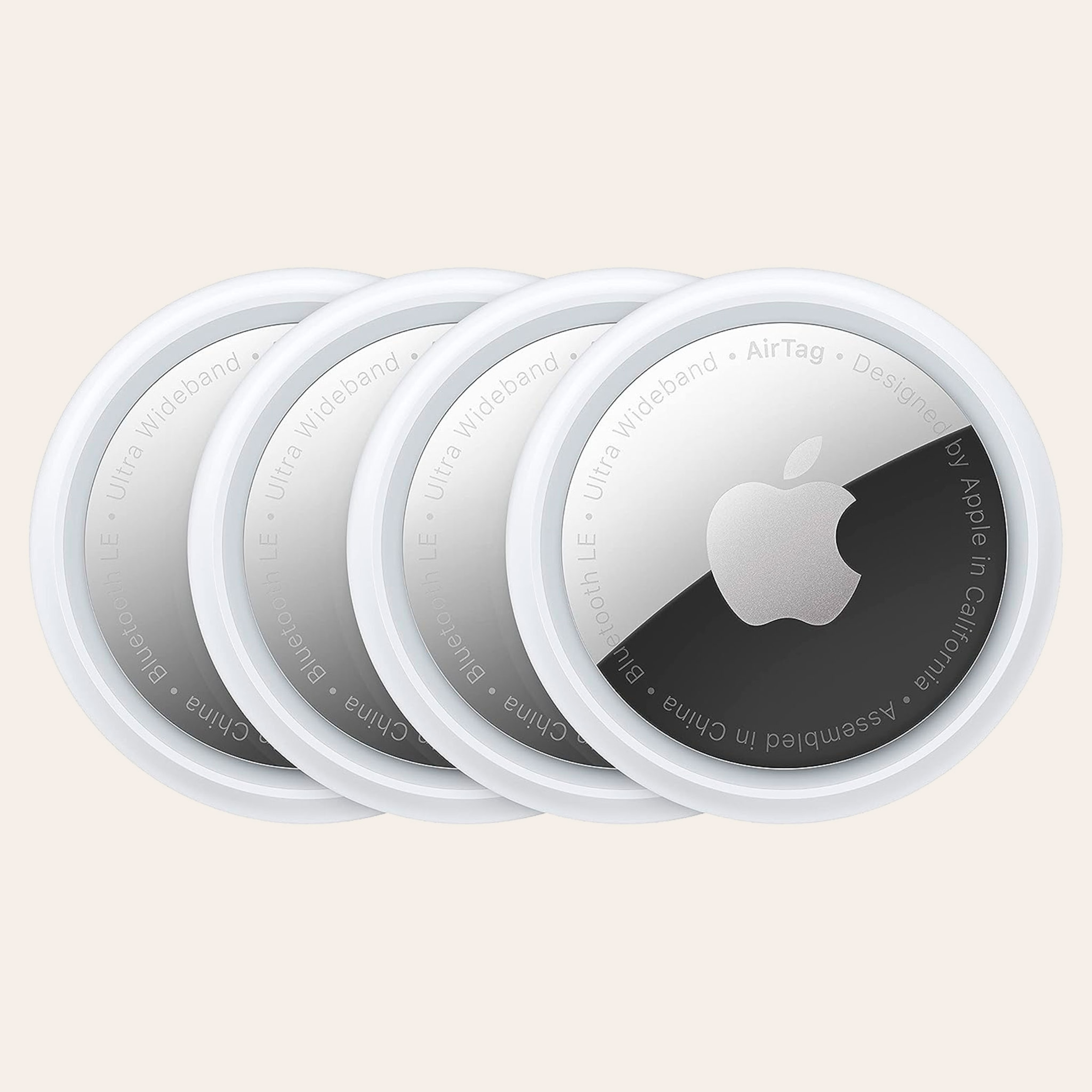 A group of 4 round Apple tags, white on the outside rim and silver in the middle