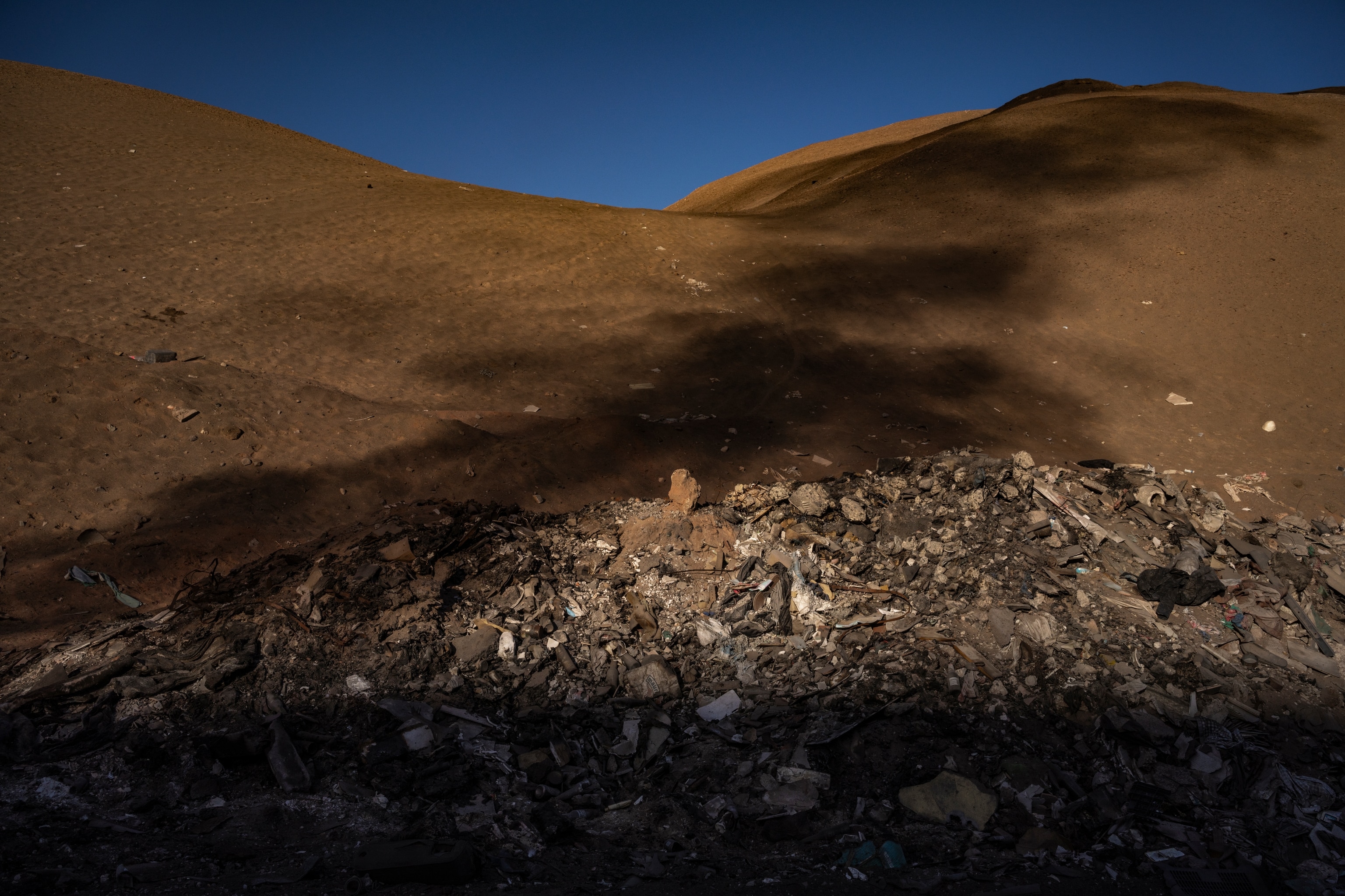 pile of clothing with a shadow cast over