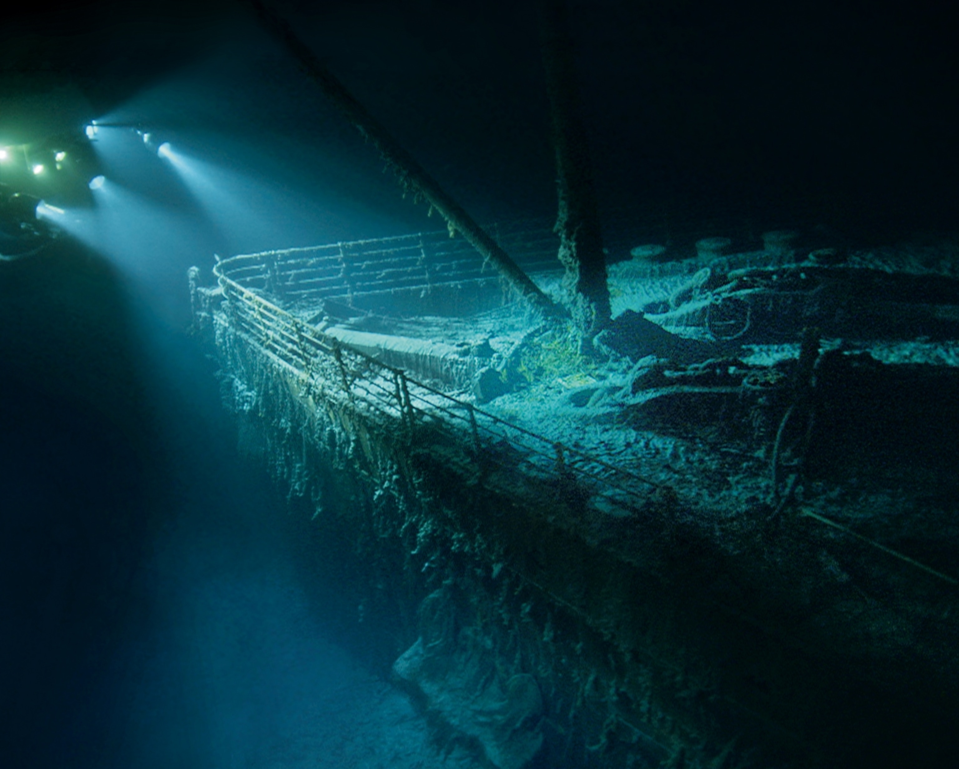 the ghostly bow of the Titanic emerging from the darkness during a dive