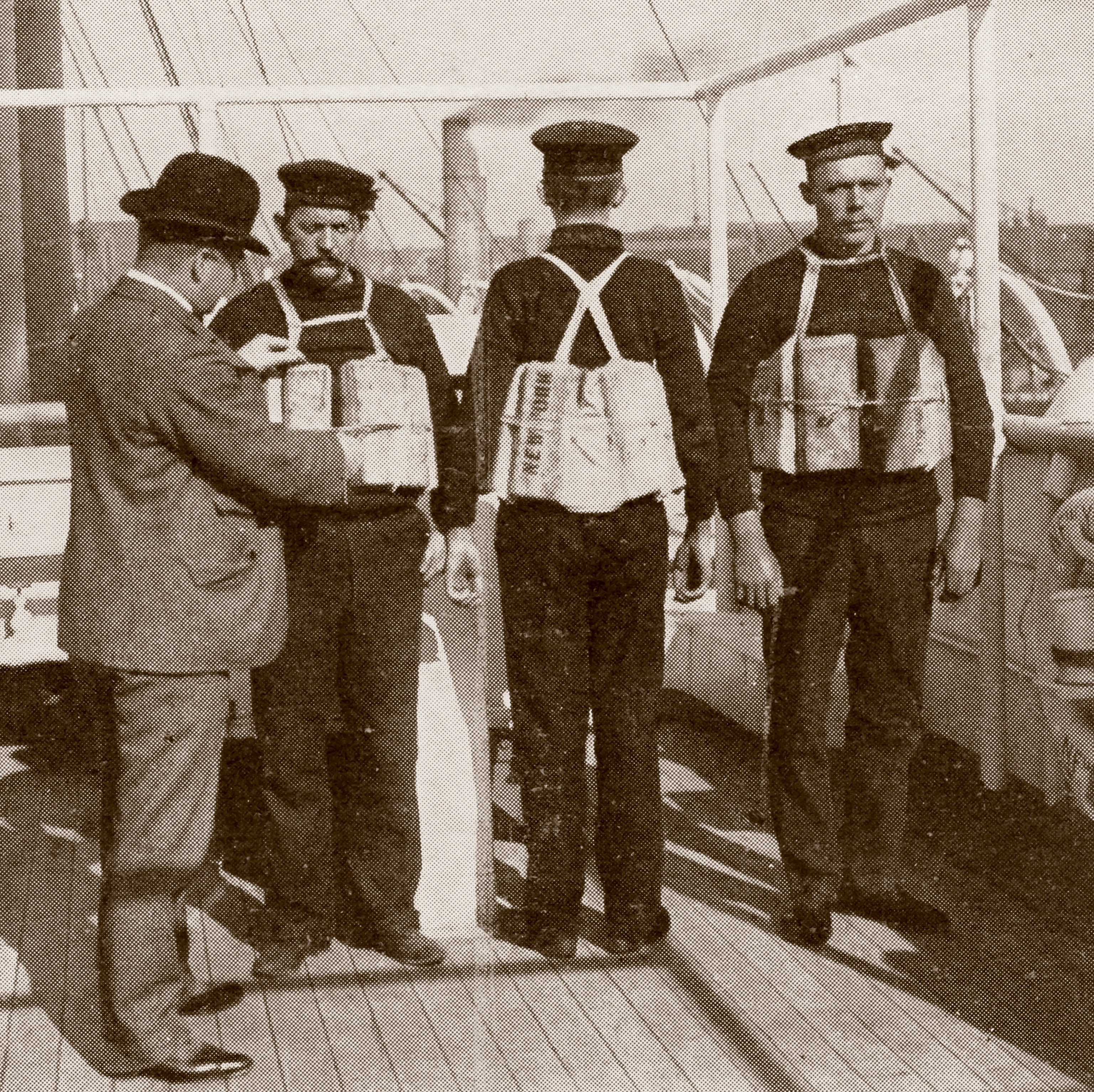 In Southampton, England, a Board of Trade inspector examines the life jackets aboard the Titanic.