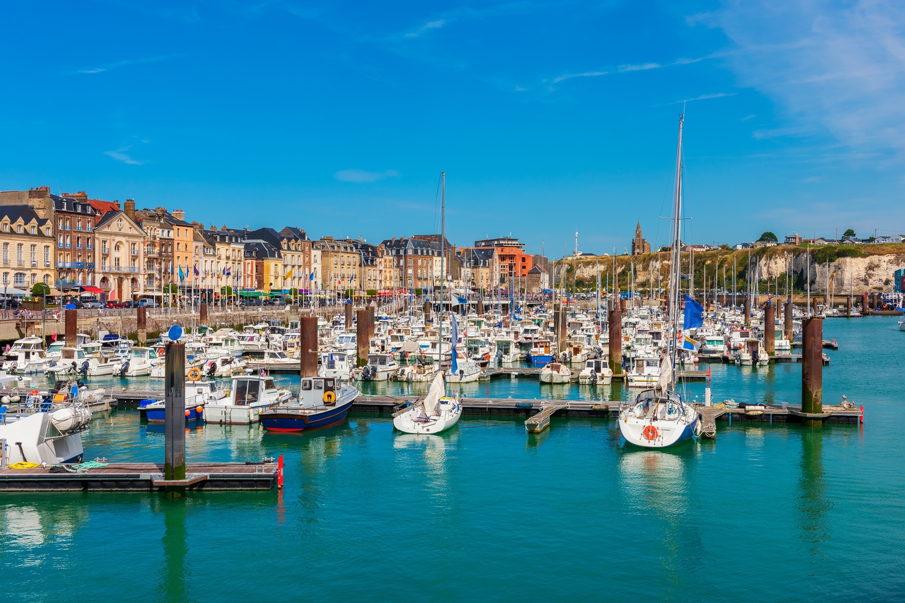 Fishing boasts moored at a town harbour lined with colourful buildings