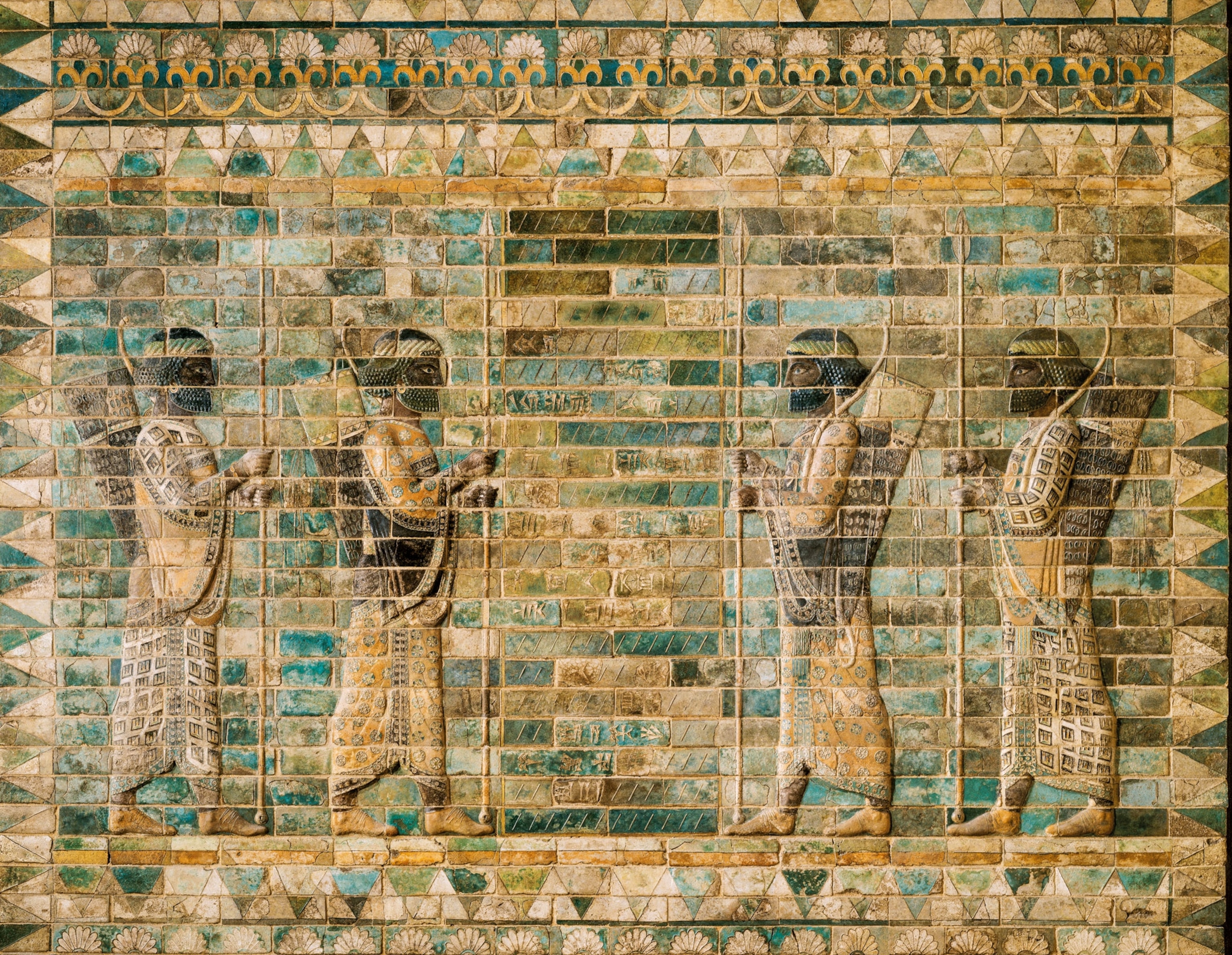 A wall of colorful bricks depicting people