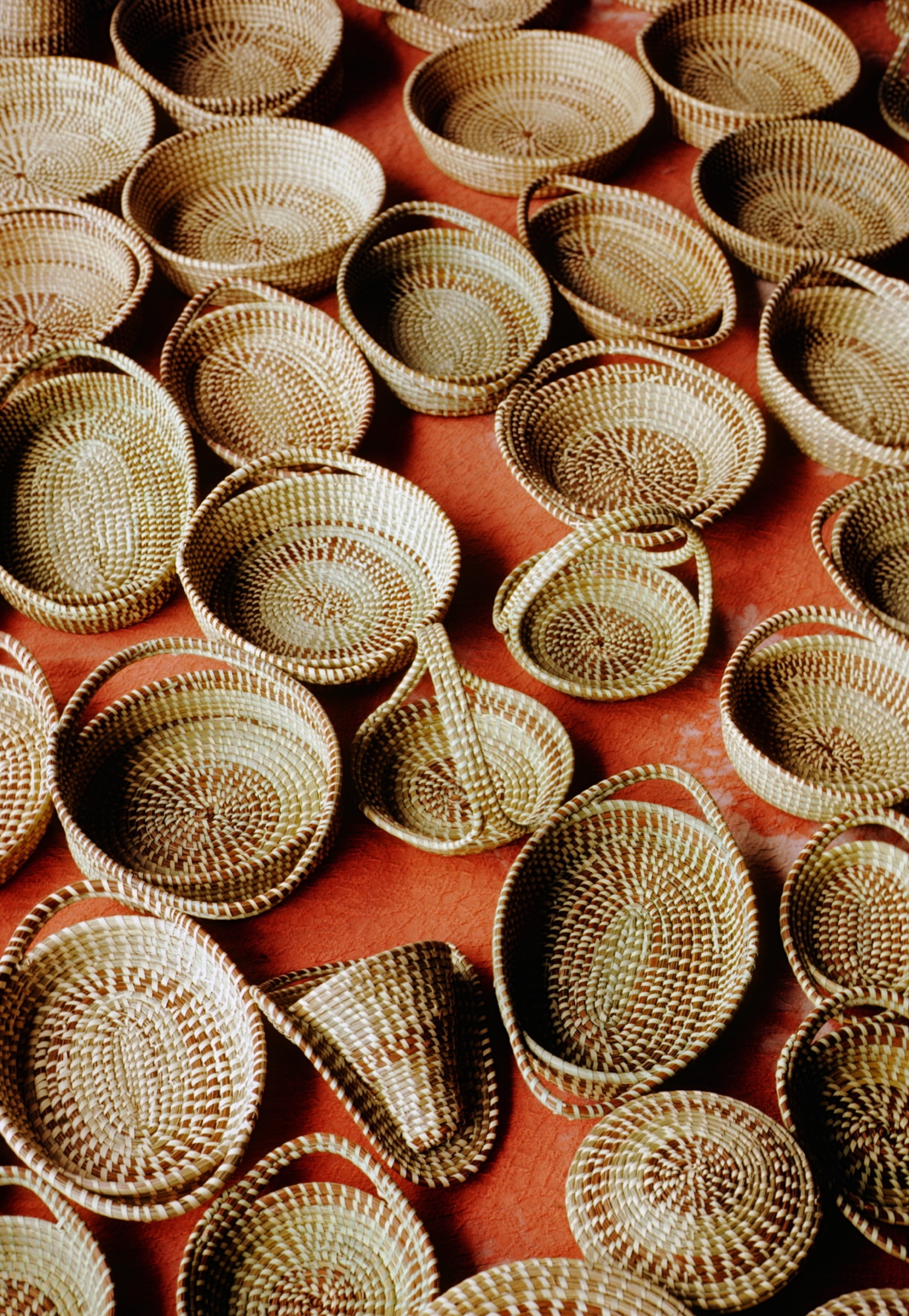 woven baskets against an orange backrgound