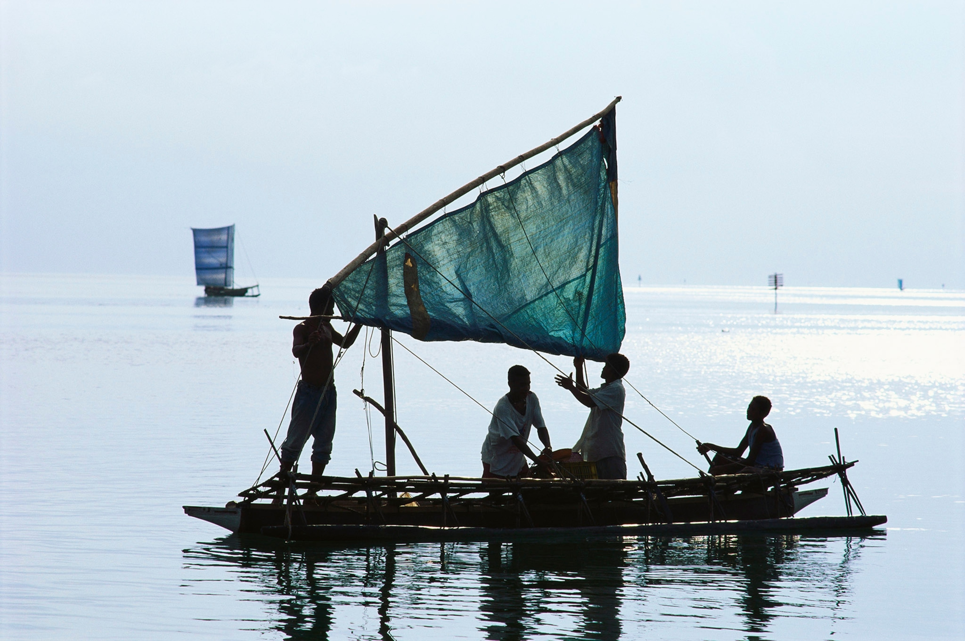 people raising a sail