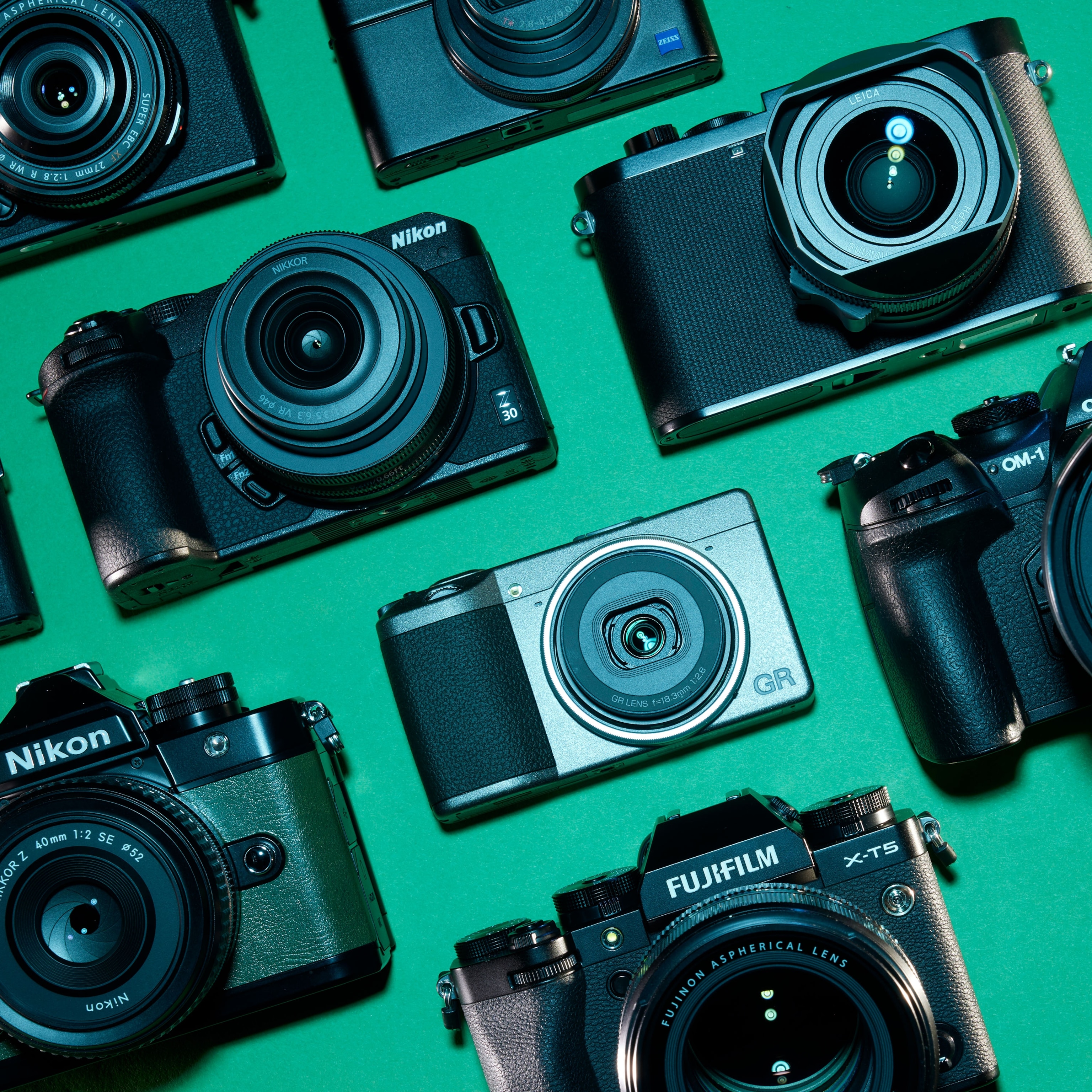 Overhead studio view of the 2023 travel video cameras of the year against an orange background