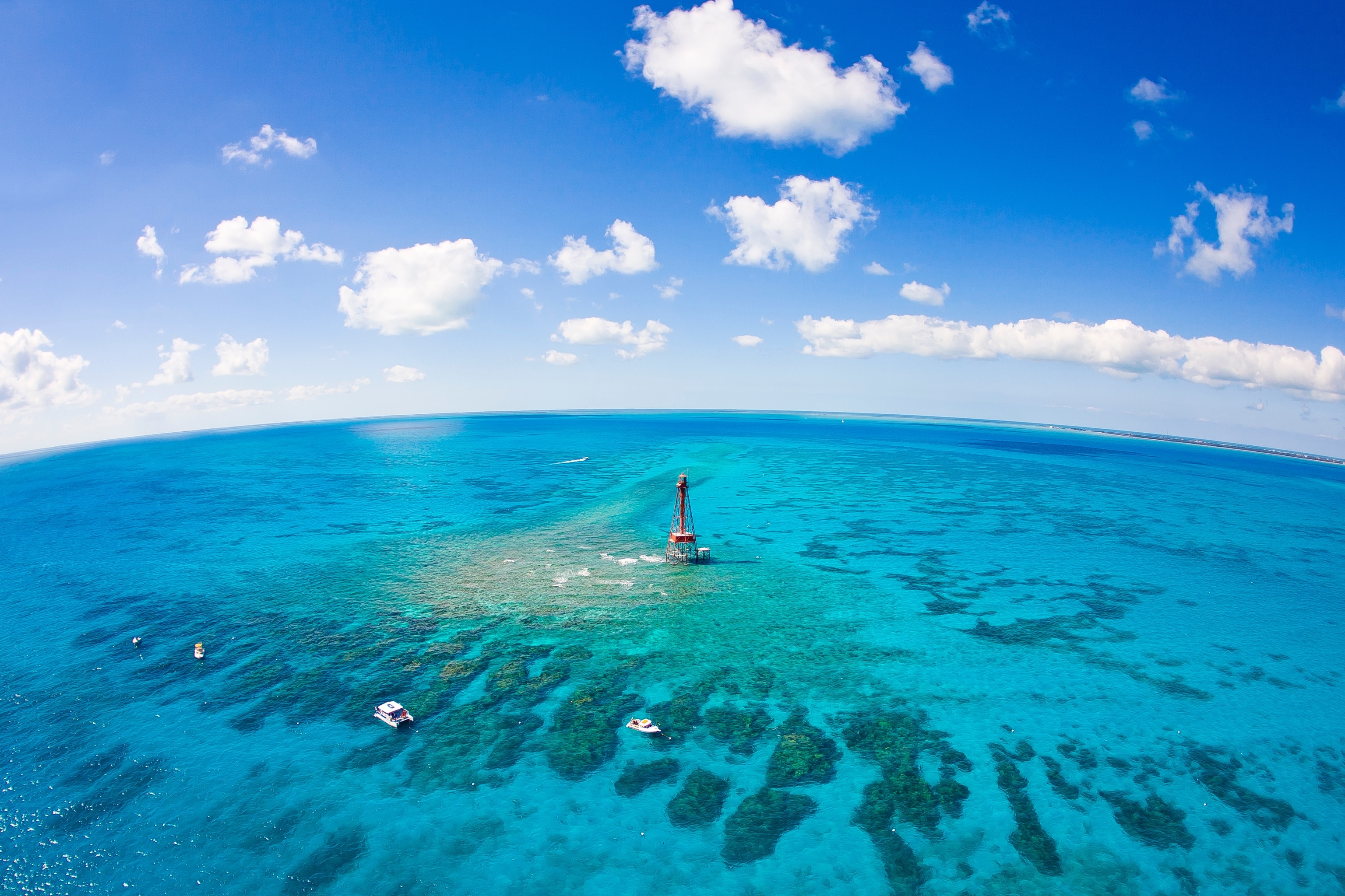 Aerial view of diving and snorkeling boats at Sombrero coral reef system off the Florida Keys during spring extreme low tides.