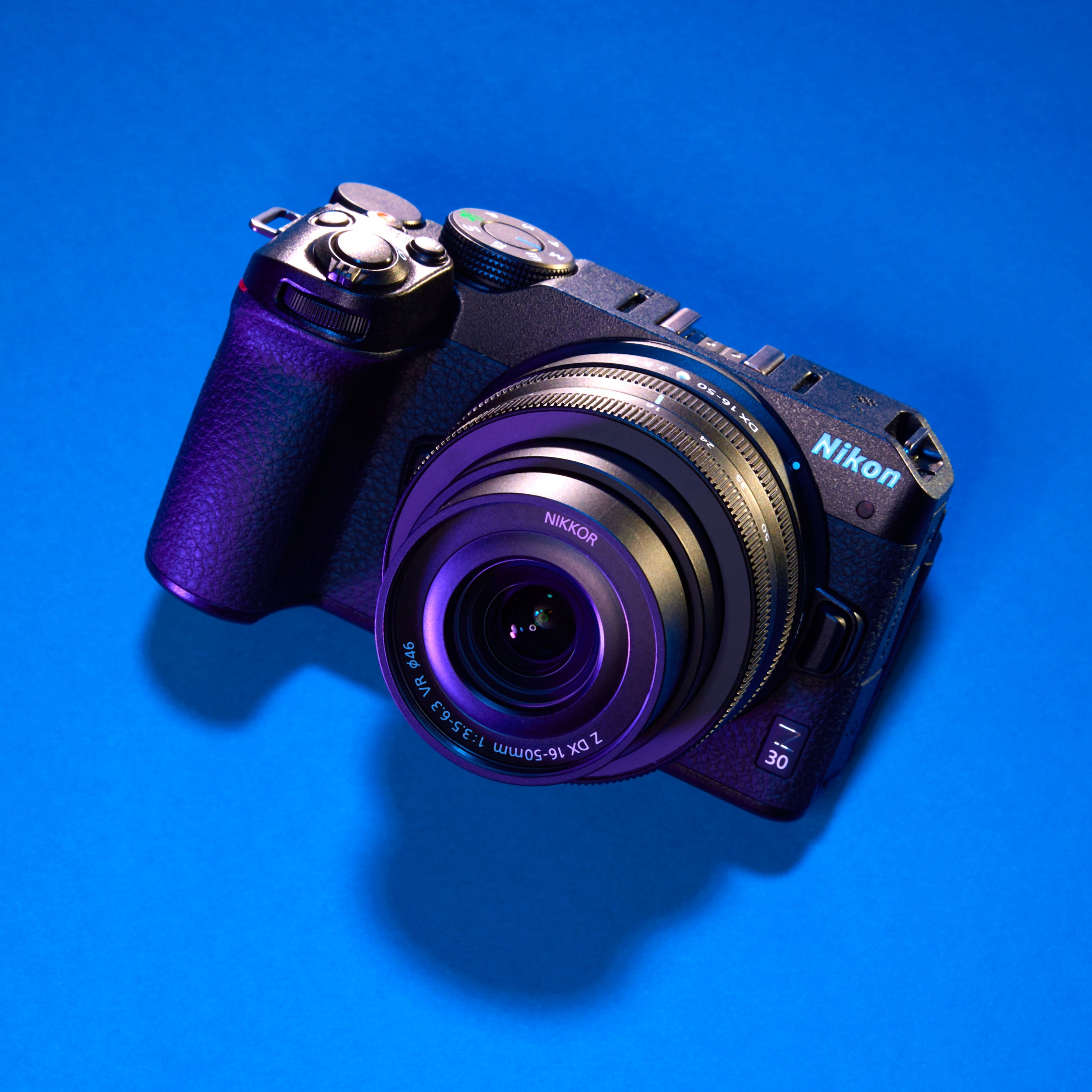 Studio photograph of the Nikon Z30 camera against a blue background