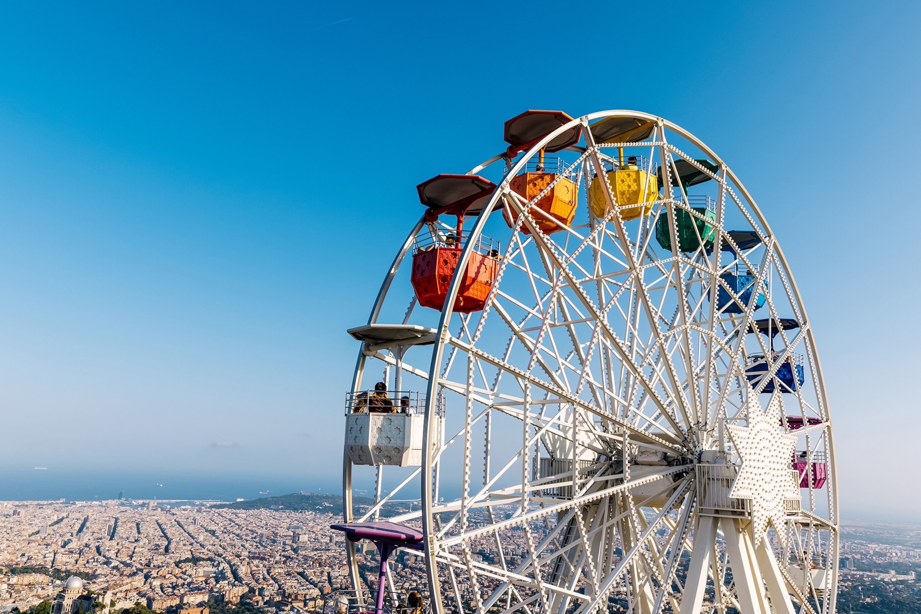 A Ferris wheel with a cityscape in the background