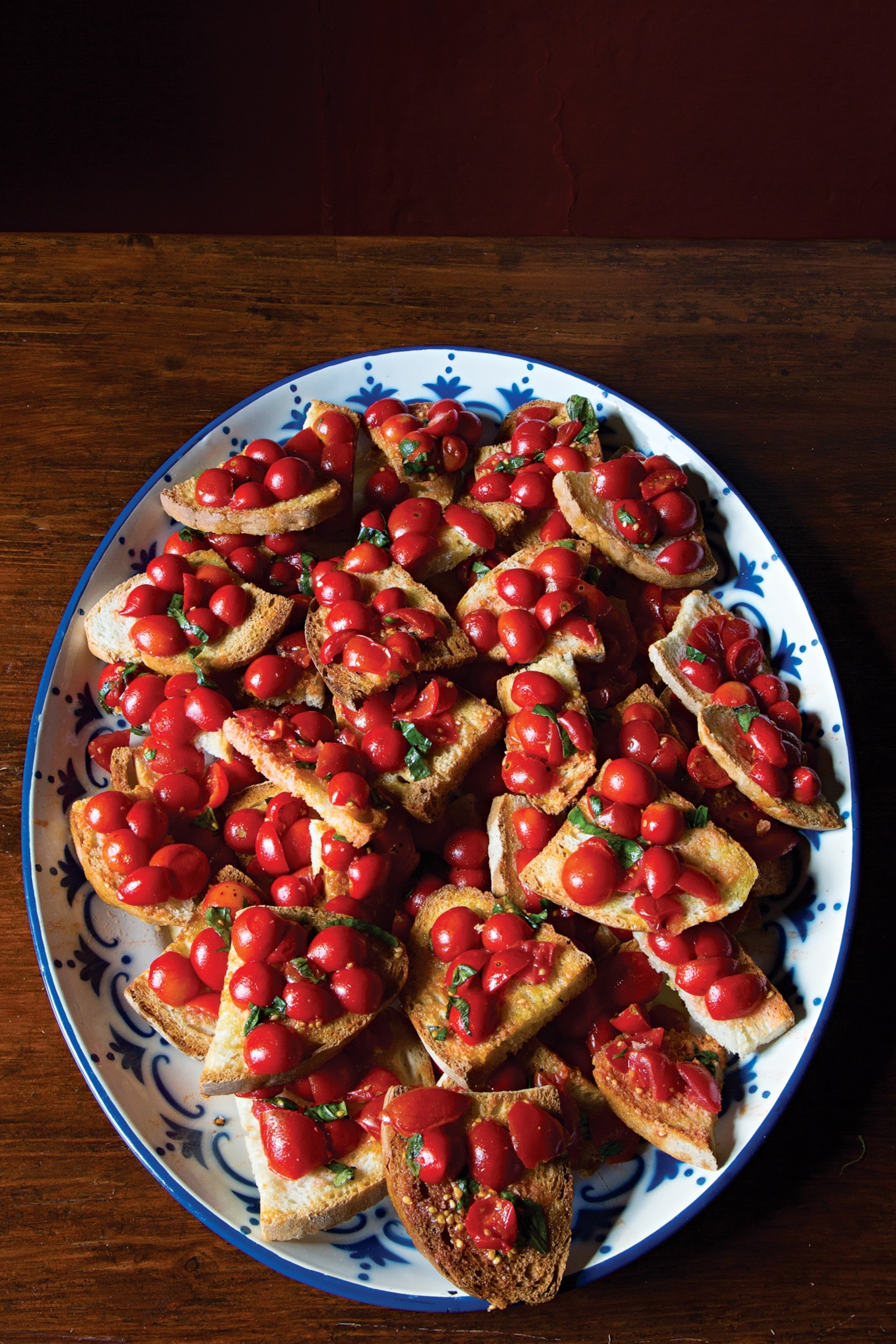 Tomato's are bright in color and on small pieces of bread.