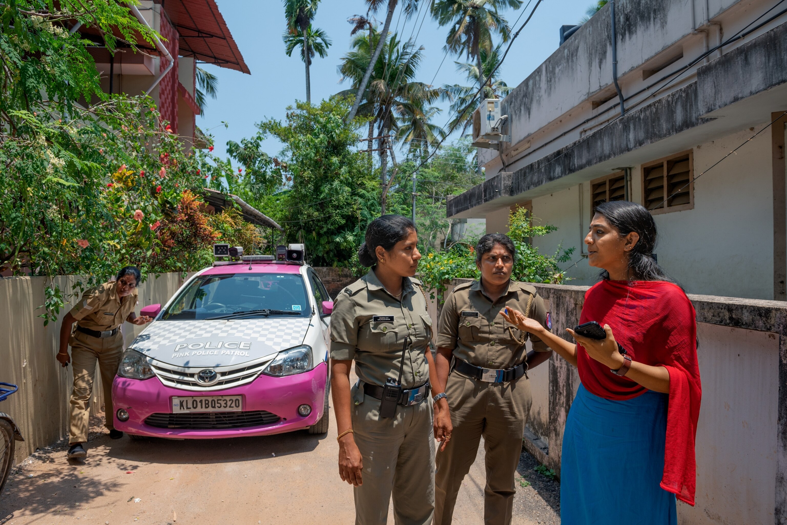 two women police officers speaking to another woman