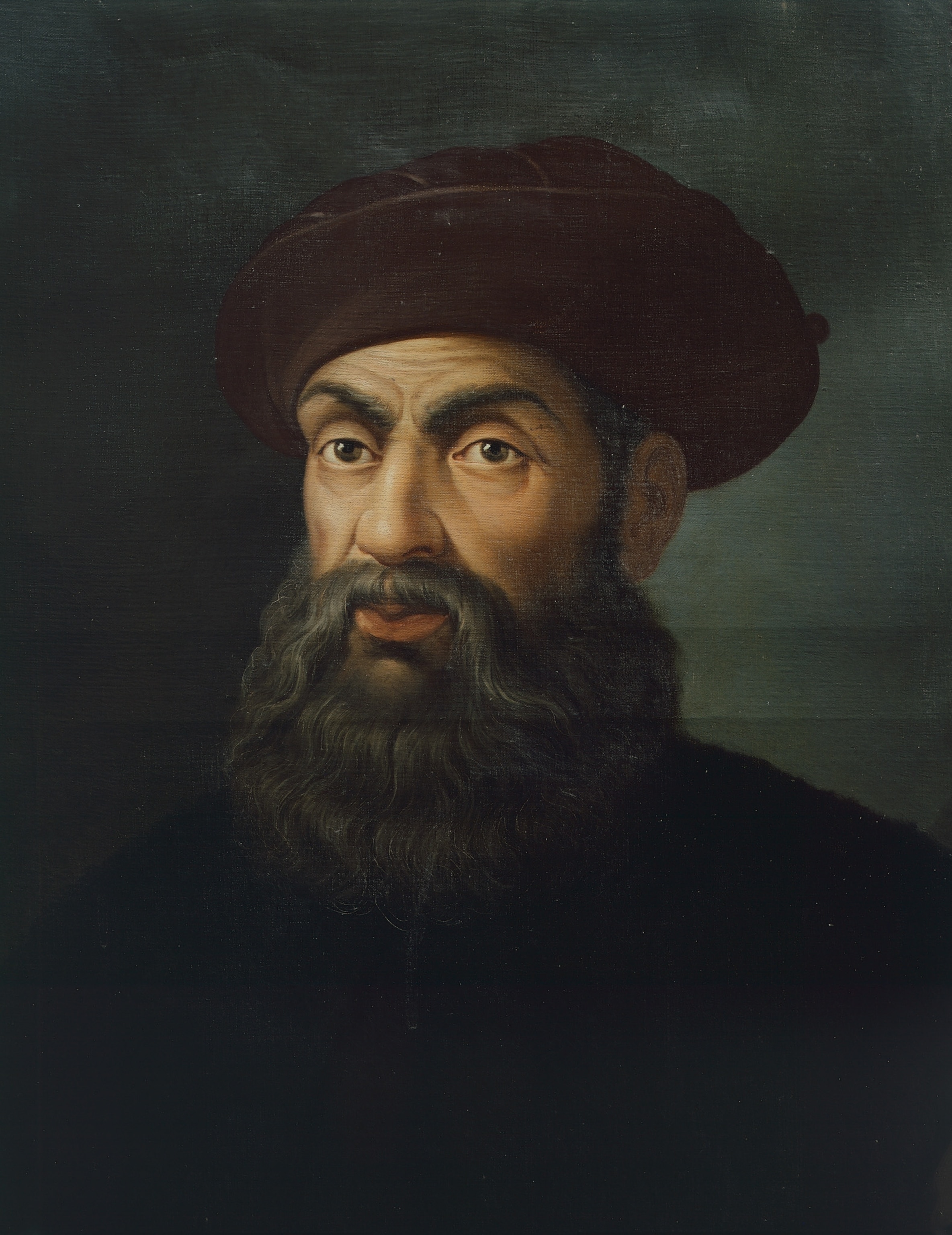 a beaded man wearing a dark red hat