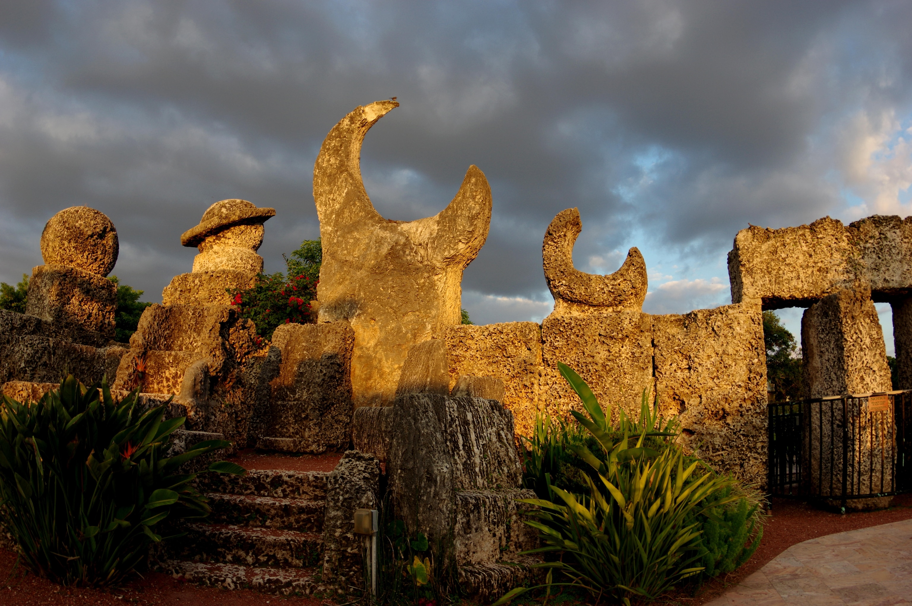 sun shines on a crescent moon and other planetary shaped sculptures