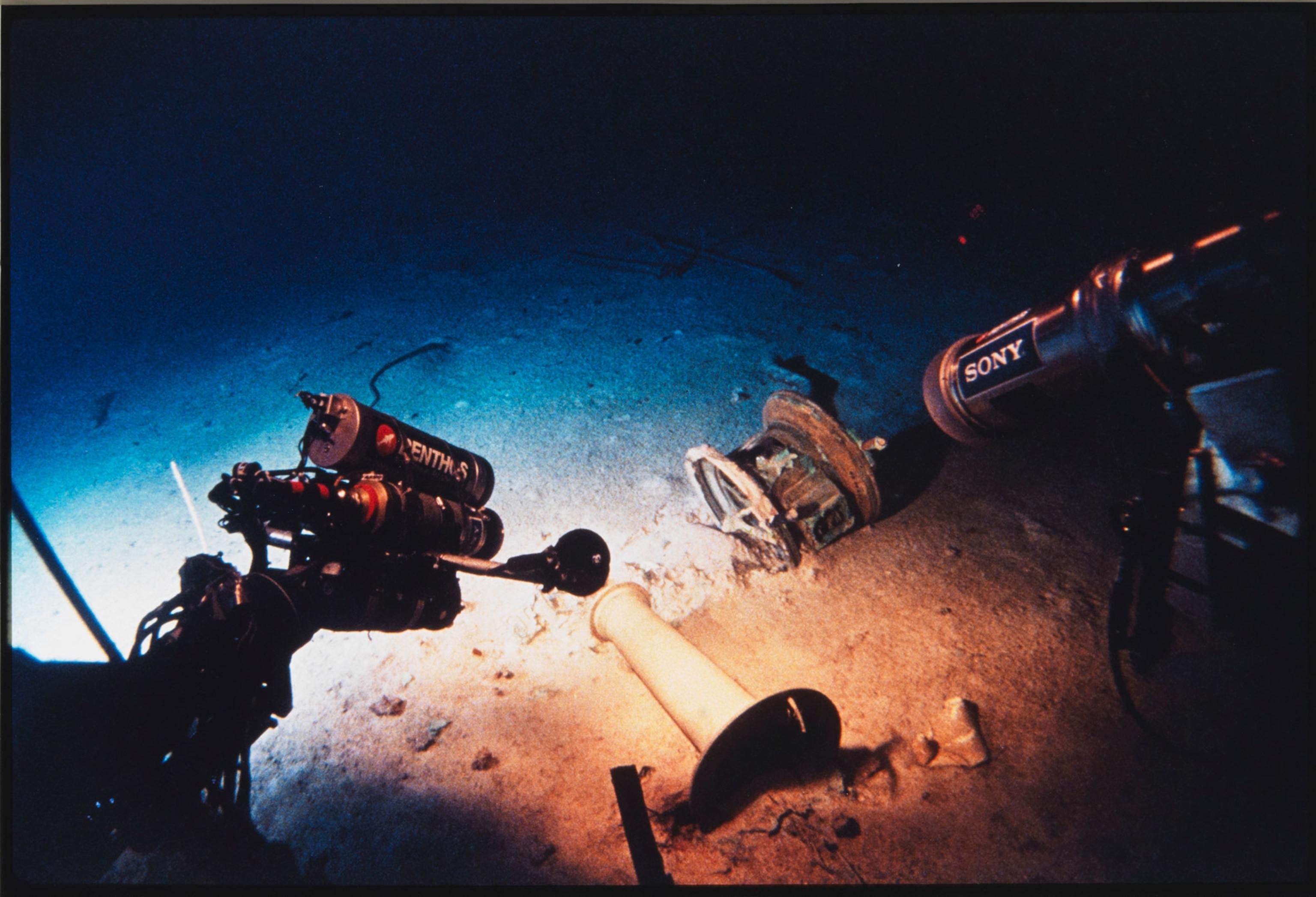 Underwater vehicle shines a light on pieces from the Titanic while filming the artifacts.