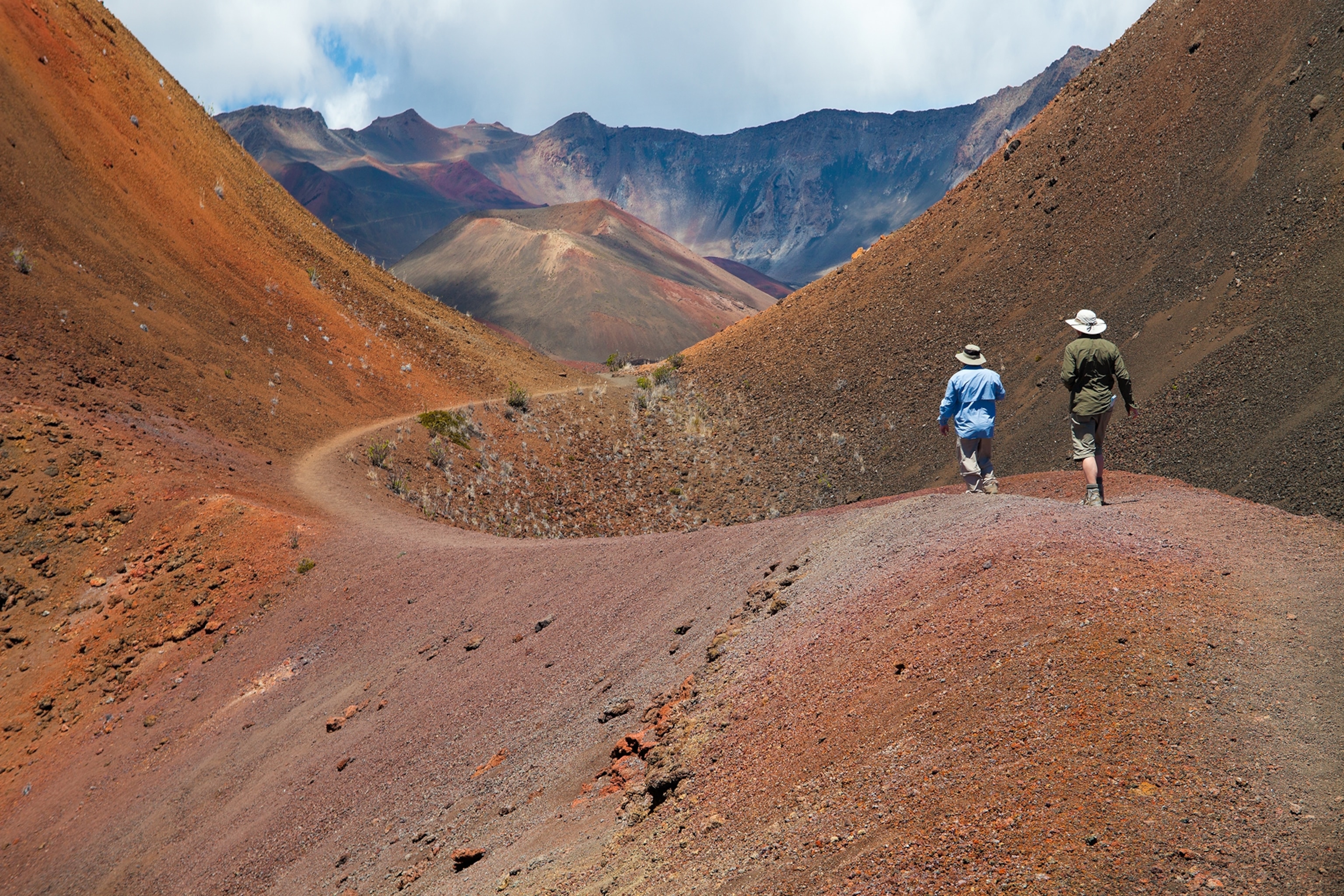 Pele's Paint pot in haleakala National Park, Maui, hawaii. Two hikers going through an area known as Pele's paint Pot. Haleakala National Park, Maui, Hawaii