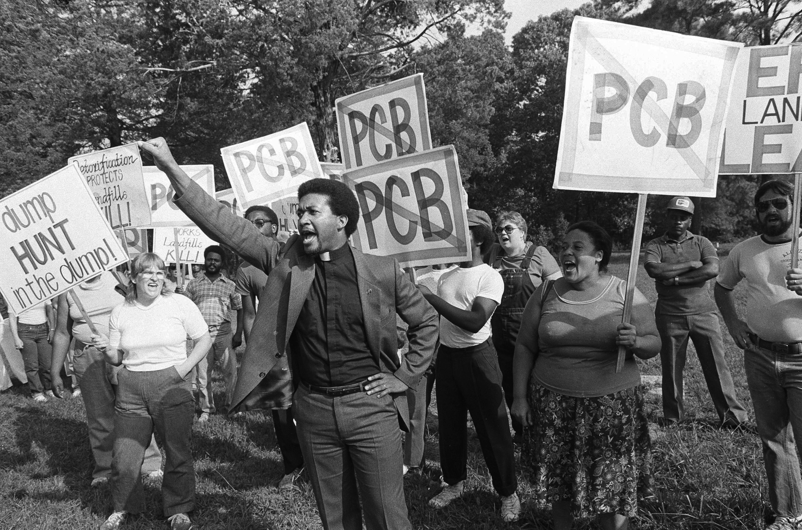 Reverend Ben Chavis with protesters with signs outside PCB landfill site.