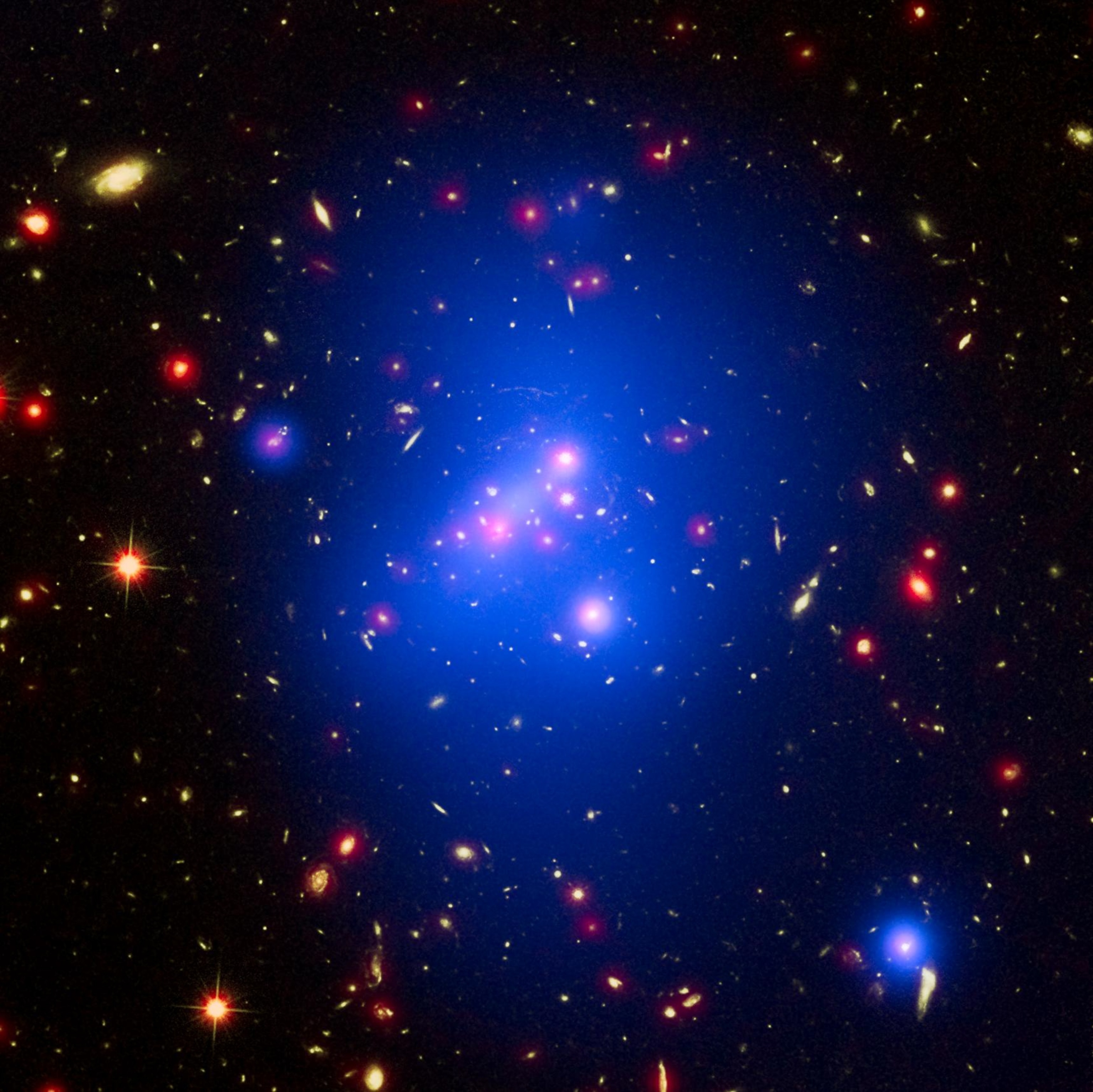 A cluster of galaxies among a blue-purple cloud of visualized x-rays.