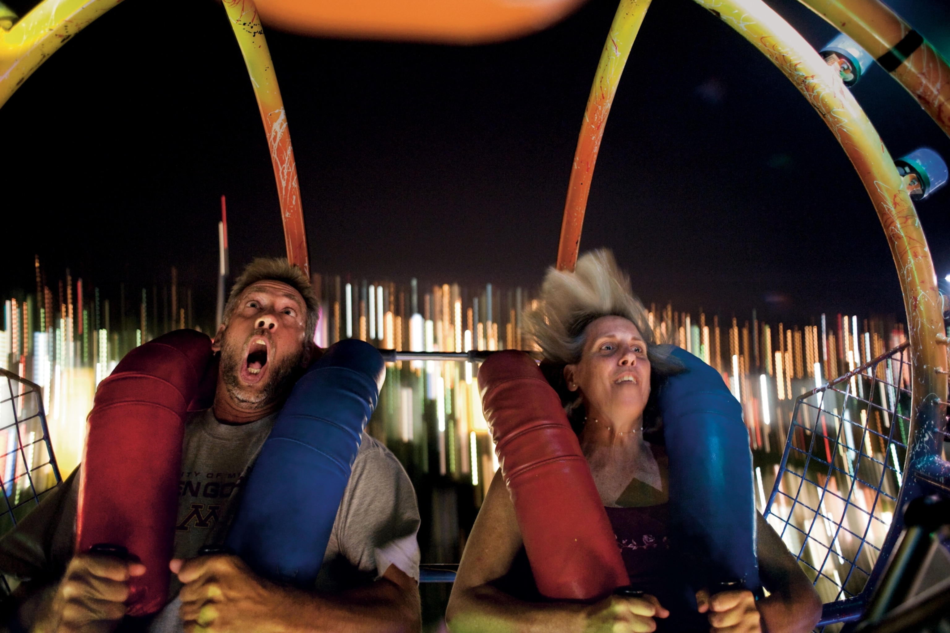 The excited and scared faces of fairgoers on a ride at the Minnesota State Fair.