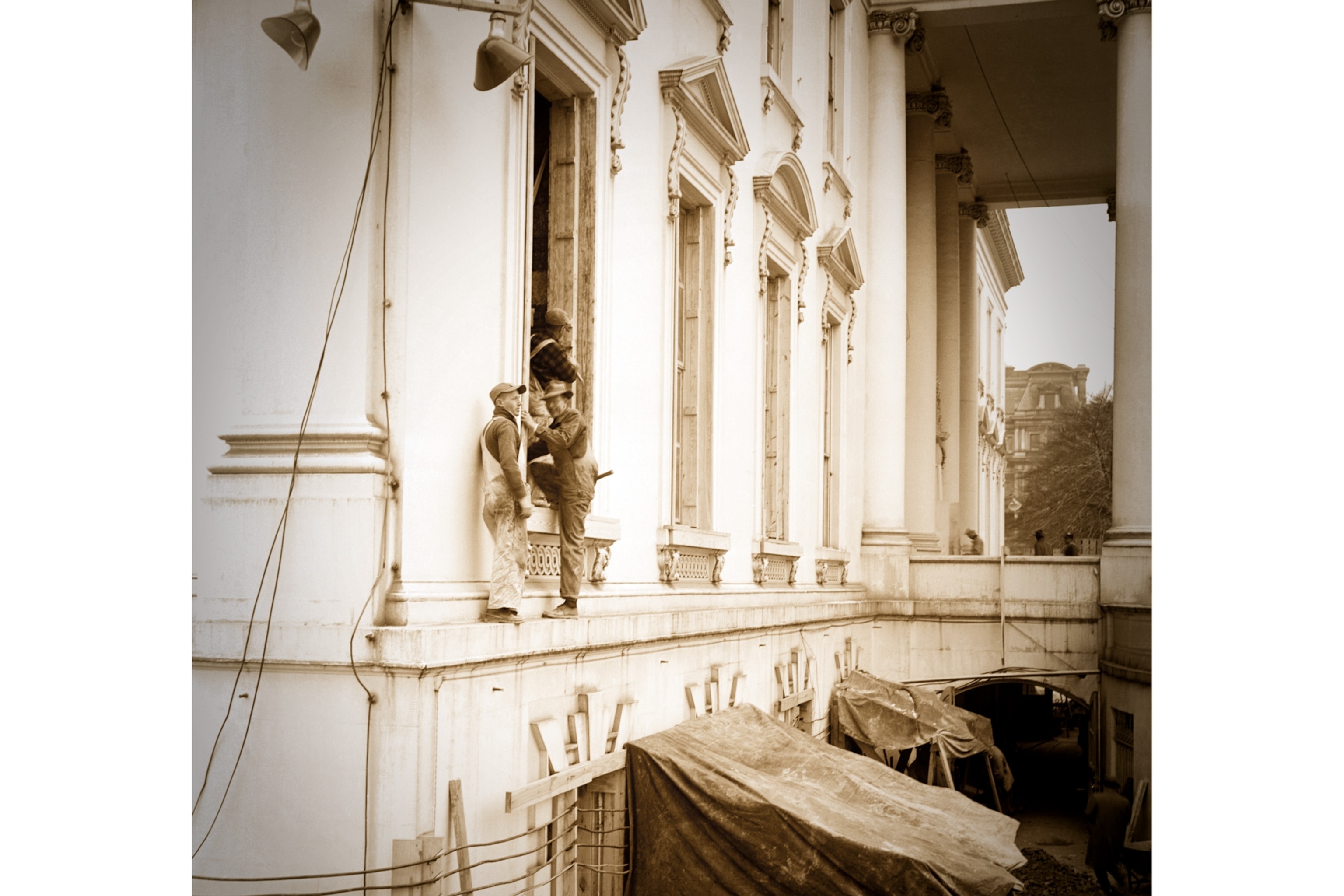 workmen replacing White House windows