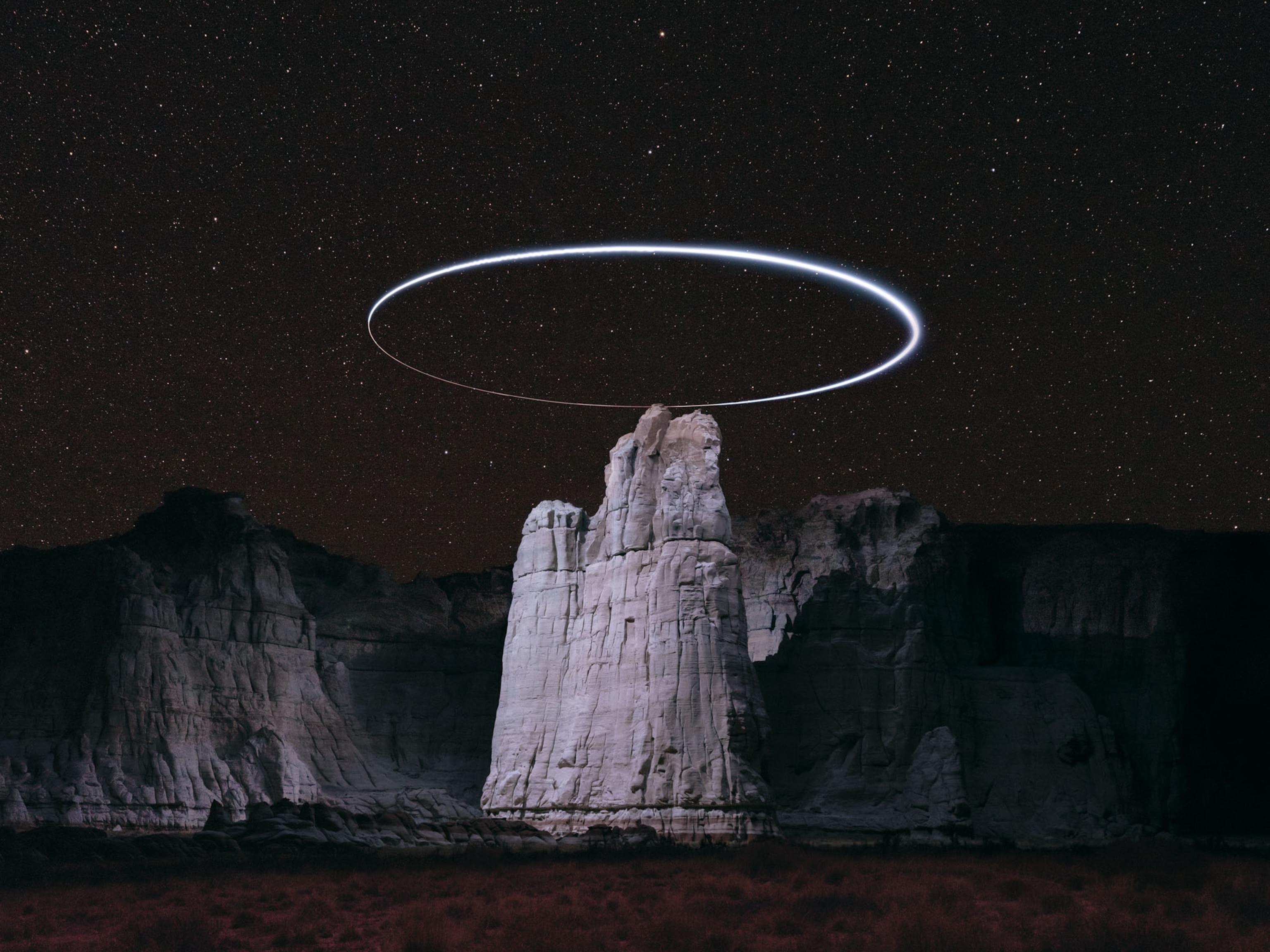 oval halo over rock tower.