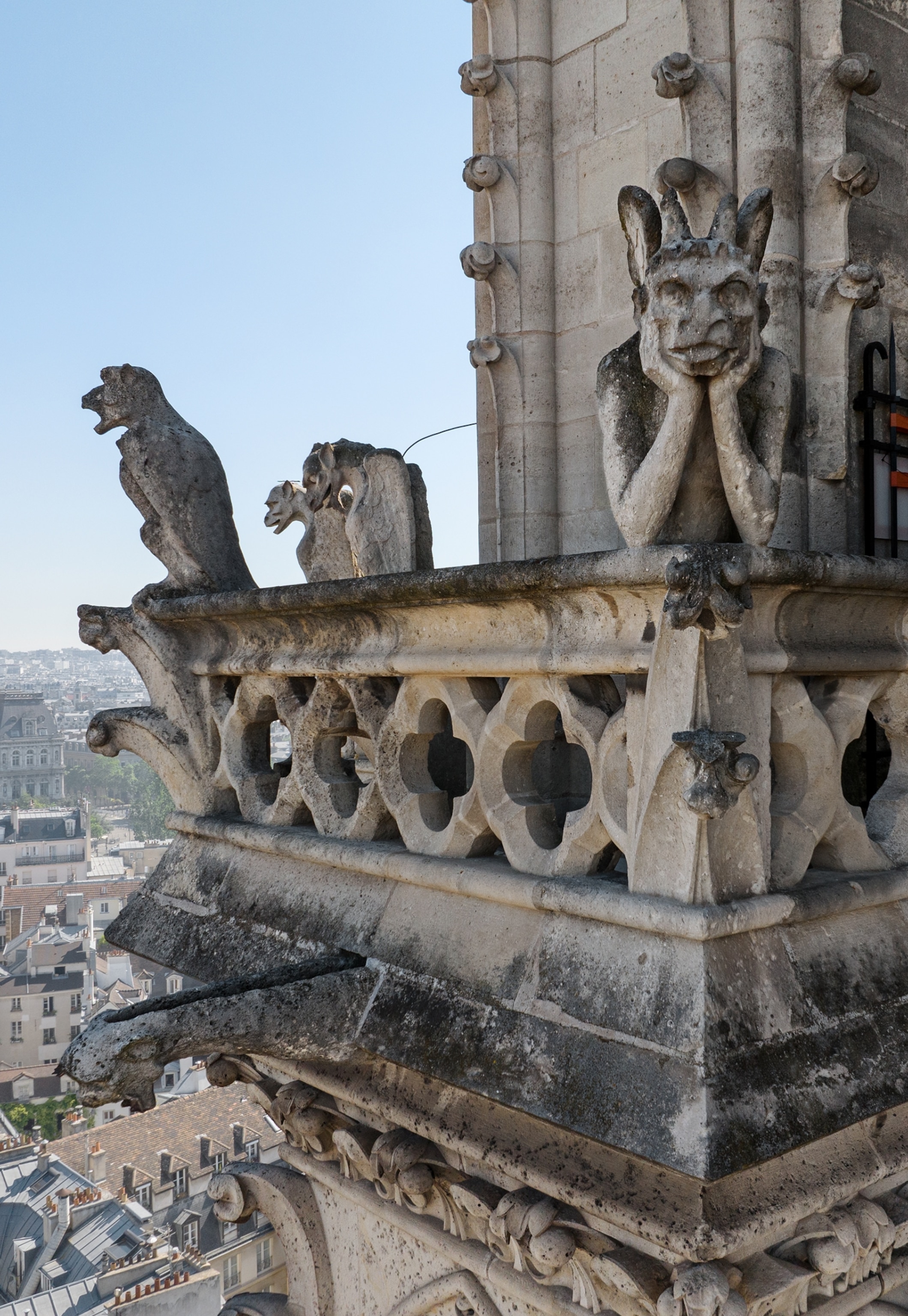 High atop the bell towers, beloved grotesques overlook the city. The one in the foreground is known as Le Stryge. Notre Dame features both grotesques, which are decorative, and gargoyles, which double as rainspouts.