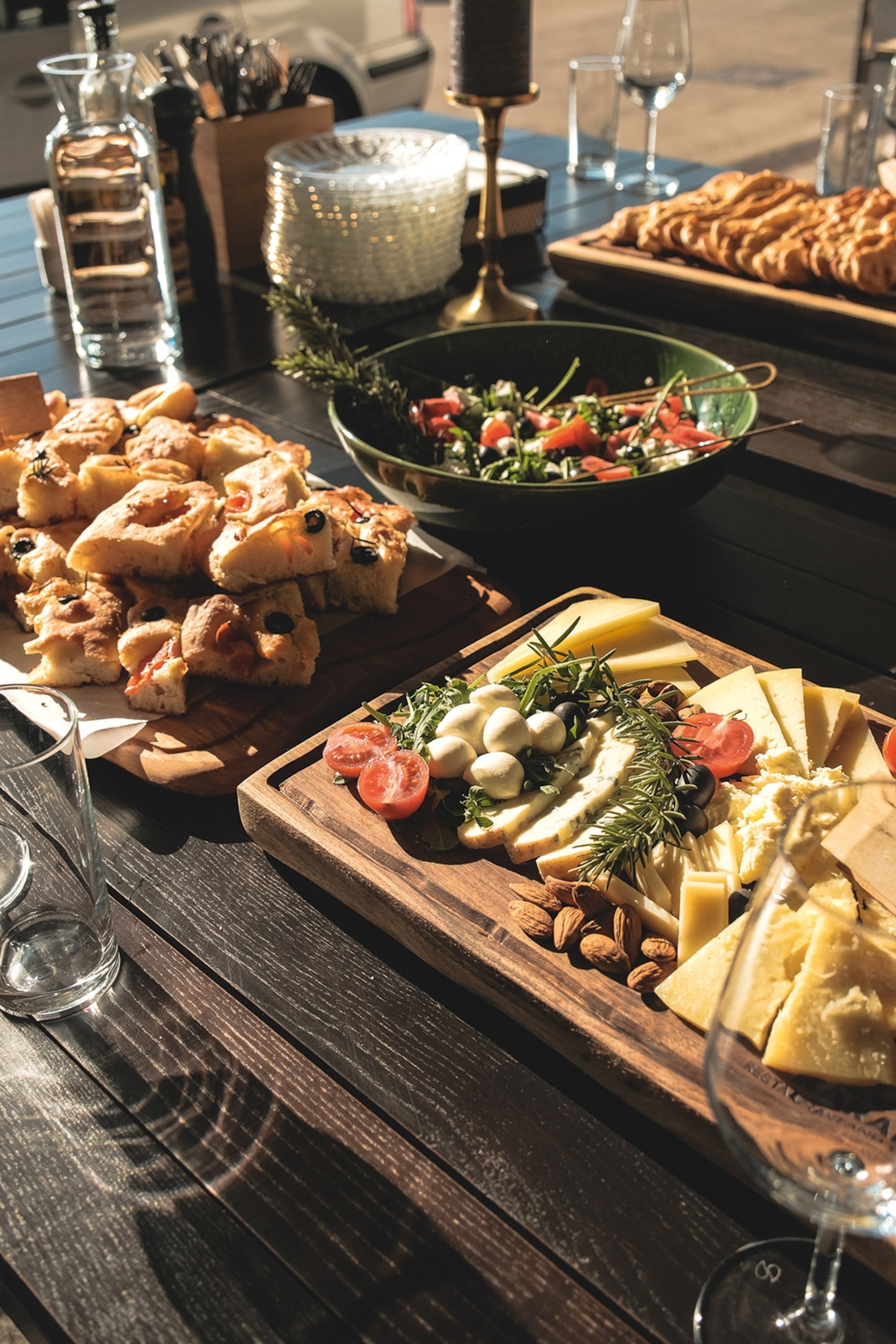 Cheeseboard presented on a table with bread salad and crackers