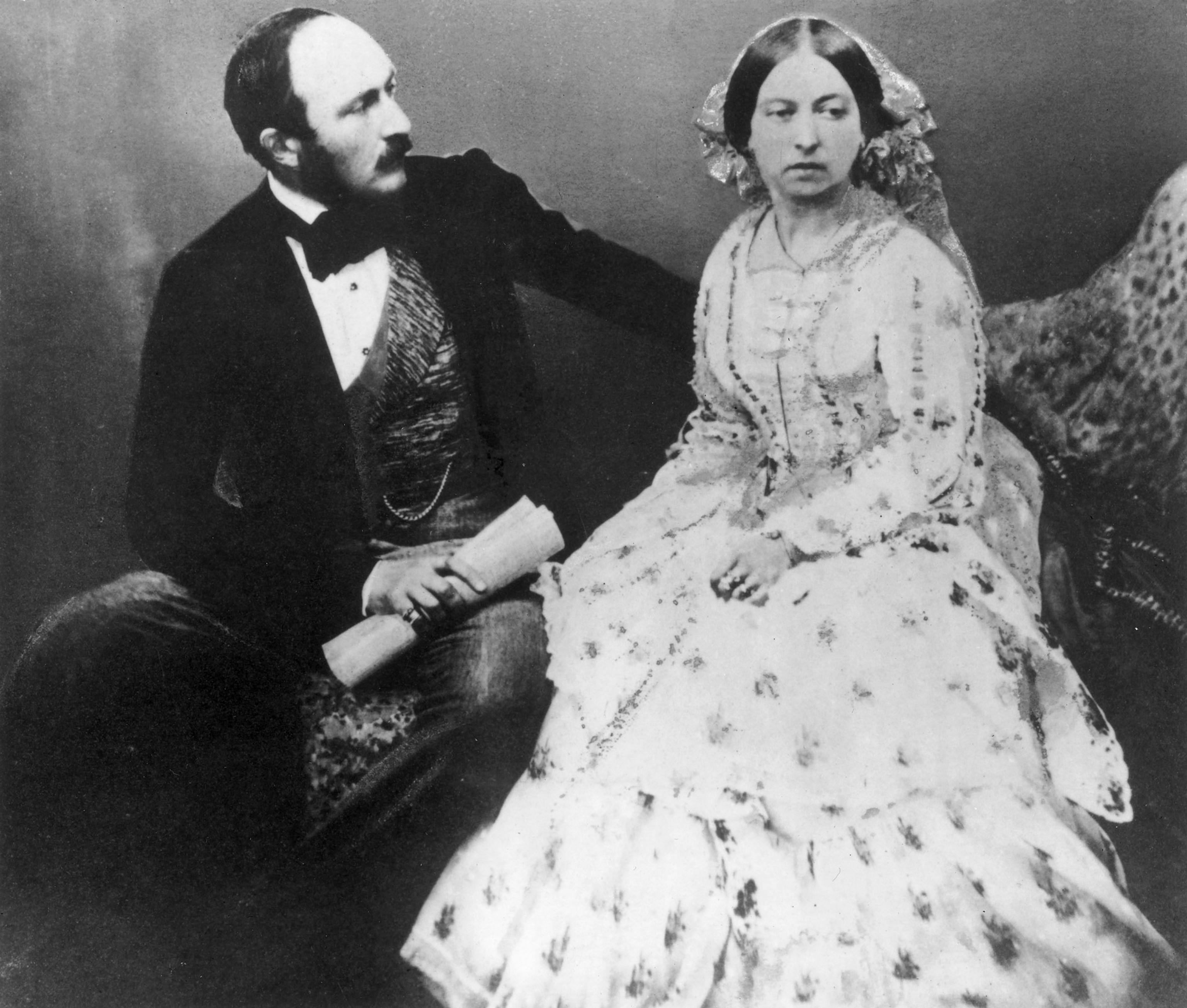 A portrait of a man and a woman sitting next to one another
