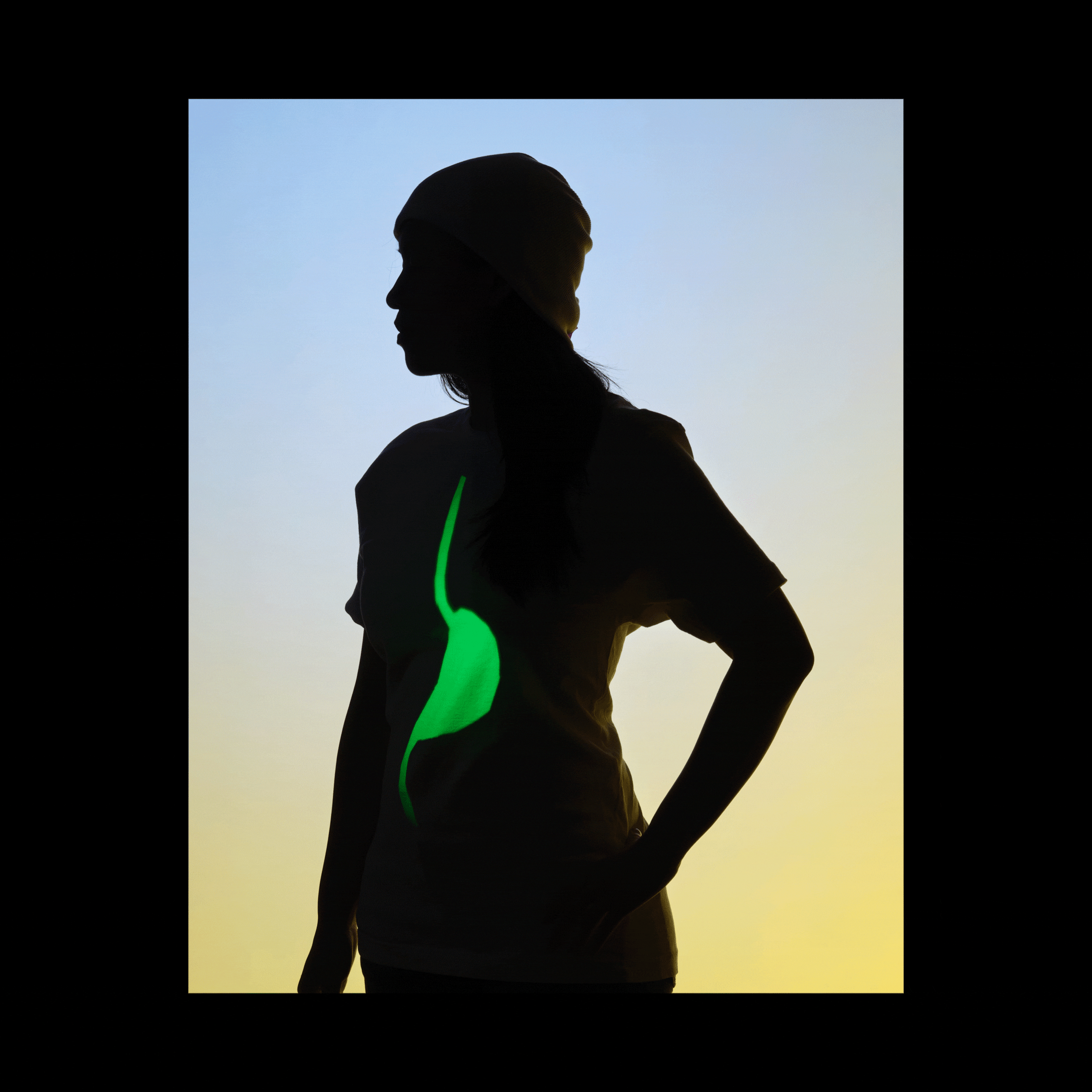 A woman silhouetted against a background that fade from blue to yellow; projections of a brain, stomach, and uterus cycle every second, appearing on the silhouetted woman's body