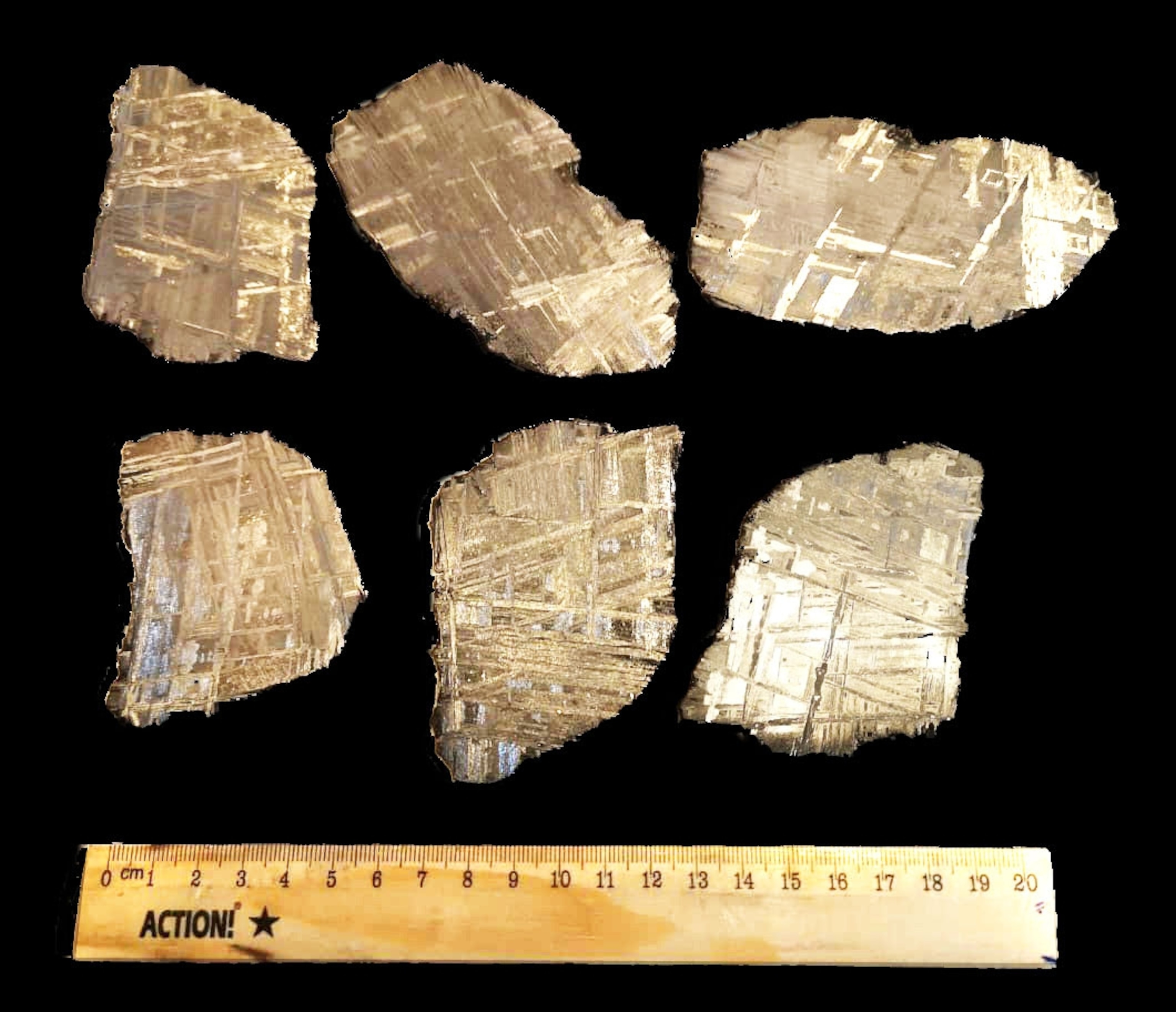 six slices of iron meterorite on black