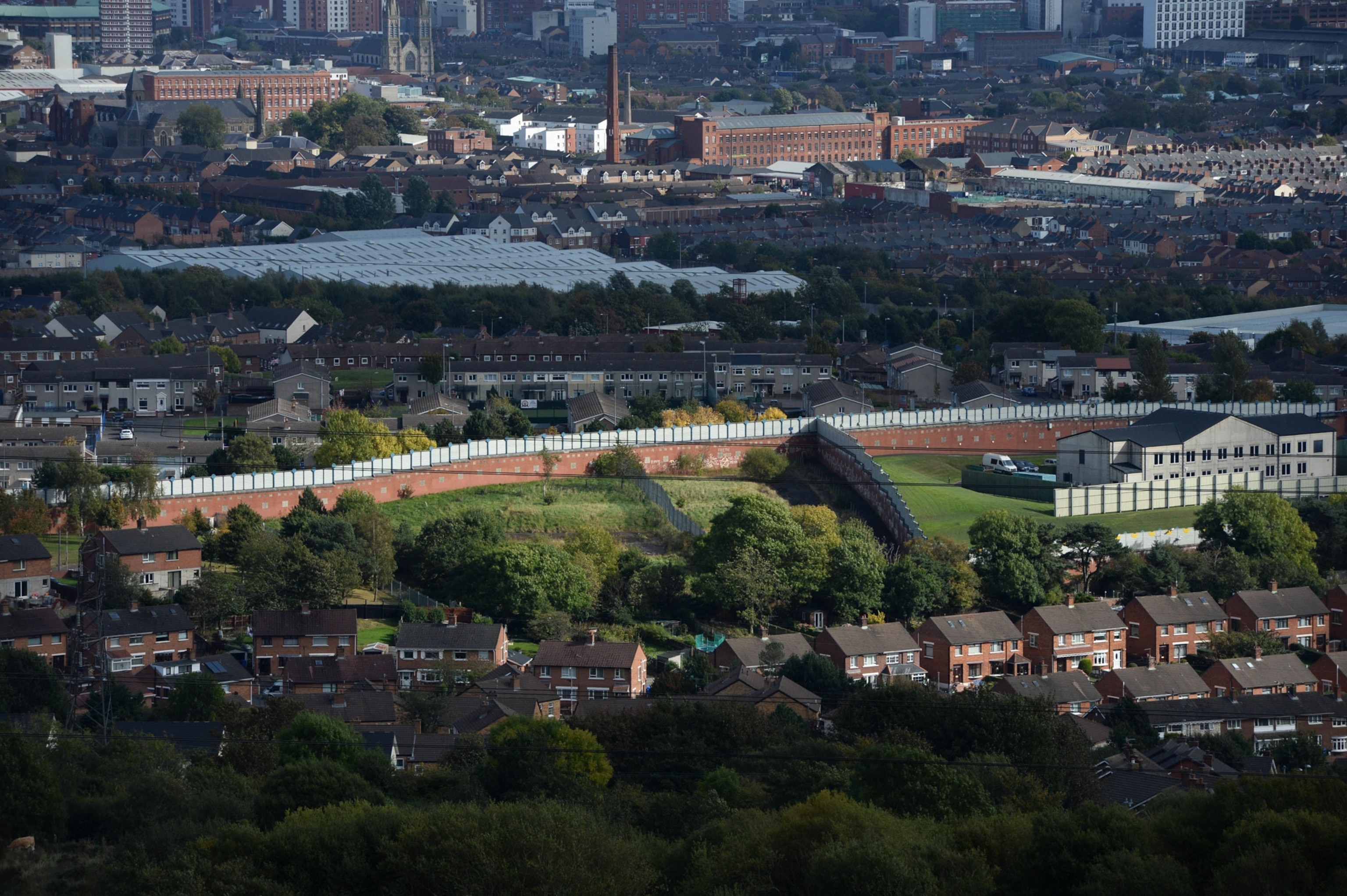 a wide landscape view showing an 18-foot-high wall in Belfast